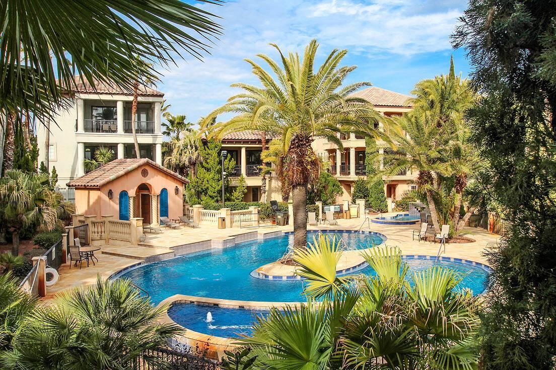 This unique Tuscan home epitomizes luxury and comfort. Located within the gated community of St. Tropez on Old Scenic Hwy. 98, the property is within walking distance of the beach, shopping, and restaurants, making it the perfect spot for a vacation or an exceptional rental investment.

Upon entering the home, you will discover two bedrooms and two en-suite bathrooms on the first floor, along with a laundry room and access to a vast covered patio that offers direct access to the pool.

As you ascend the stairs, you will find the primary bedroom, which features a large walk-in closet and an en-suite bathroom equipped with a separate shower and a spacious garden tub. The kitchen is open and includes granite countertops and a gas stove, providing ample space for large gatherings.