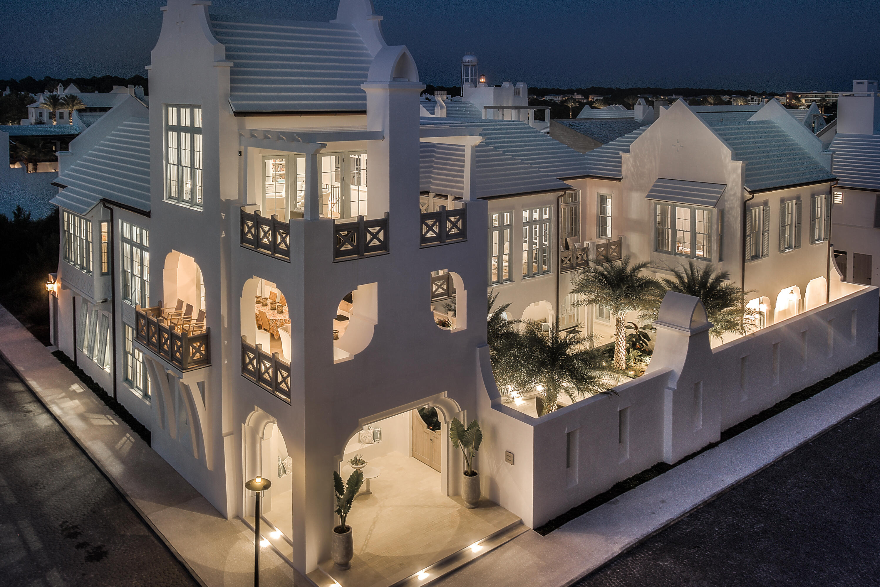 Latitudes & Attitudes is the quintessential Alys Beach home.  This premier, double lot property resides at the corner of the famed South Charles & Sea Garden Streets lending itself to one of the most dramatic elevations Alys Beach offers.  The entry gate opens to a breathtaking courtyard canopied by the majestic Mejool Date Palms with sofas beneath to enjoy the fireplace by night. Entering the home's first floor welcomes you to a secondary family room opening to both the North & South courtyards.  The North courtyard yard with private pool allows for complete privacy for swimming & sunning.  The secondary family room is a gathering space to accommodate the four guest suites at this level. Each of the 4 bedrooms host en suite bathrooms plus one of two powder rooms. Each bedroom is outfitted with its own custom furnishings & design elements. Ascending to the 2nd floor by way of the open staircase brings you to the main living level framed by reclaimed beams set to the apex of the vaulted ceiling. The 2nd floor features views of the Gulf of Mexico from most locations sharing accents of the Medjool Date Palms. The living areas are flooded by natural light cascading through the floor to ceiling windows & transoms making for a peaceful setting.  The living room opens to dual balconies each having sights of the Gulf.  Seating to accommodate family & guests is plentiful. The living area transitions to the dining room & kitchen centered by the professional kitchen's double island capped with Calacatta Marble.  All chilling appliances are Sub-Zero featuring a La Cornue gas range.  Exquisite & extensive cabinetry & hardware provides use of a professional chef for entertaining if desired. The North to South alignment of the kitchen & dining room opens to the dining terrace with all 3 locations having Gulf views.  The sliding doors create connectivity to the terrace providing additional entertaining space for outdoor dining & grilling capturing the gentle Gulf breezes.  The main living terrace boasts a summer kitchen with fireplace & television to be consistent with Alys Beach's iconic indoor & outdoor living concept. Dine outside while watching the sunset sink on the Gulf of Mexico. Sitting above the outdoor terrace is a 3rd story room further emphasizing the livability of the home having its own balcony suspended above the Town.  This space is currently designed as the owner's office that can easily transition to a media room.  Views of the Gulf and the architectural roofscapes of the Town are stunning from this location. Separate from all is the beautifully appointed Master Bedroom private from the other living areas.  This is truly a space of retreat with private balcony, sitting area, and workspace which captures the landscaping below of the courtyard, water views to the South.  His & her closets are generous with custom cabinetry separating the bedroom to bath.  Designer inspired material selections in white palette soften the bathroom to be spa like. Lastly, and unique to Alys, is the carriage house having a private bedroom plus separated bunkroom.  The carriage house is perfect for extended guest visits designed with a full kitchen, dining, & living rooms.  The carriage house sits atop the 3 car garage which has additional parking for 3.  This feature is the only of its kind in Alys. This Domin Bock Architects design is an architectural masterpiece lending itself to full time residency.  This property is a must see.