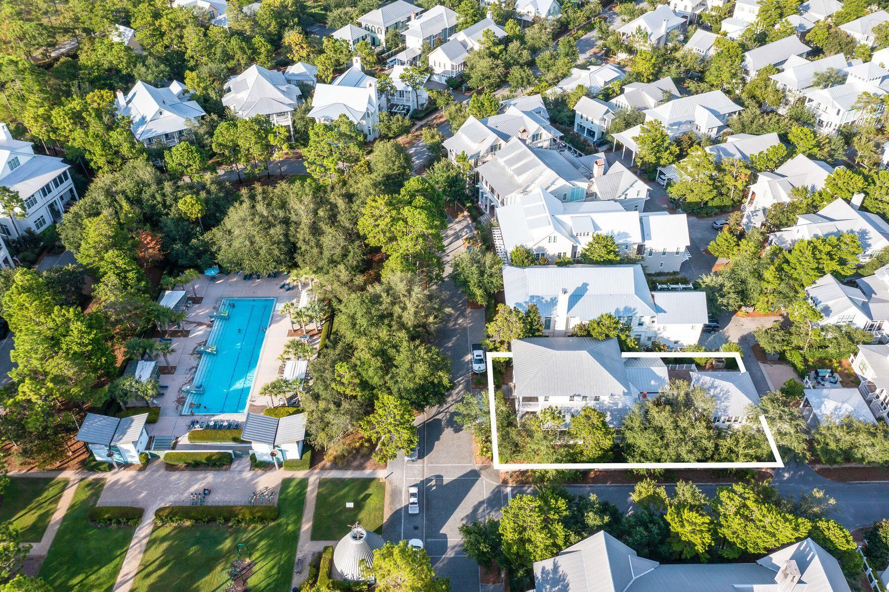 This grand remodeled home in WaterColor Phase III is on a spacious corner lot on one of the most coveted streets in the community, with a carriage house and a fenced courtyard for the ultimate in privacy. The moment you step inside you'll notice the soaring 12-ft. ceilings and expansive open living room designed for hosting celebrations and family vacations. Polished hardwood flooring and white walls, some with shiplap wainscoting, create an elegant living space that exudes a sense of well-being and peace. Make your way to the gourmet kitchen, the hub of the home, designed for entertaining or creating snacks and drinks in moments. The well-planned space includes chef-quality Sub-Zero and Wolf appliances while the smoothest soapstone counters on the breakfast bar demonstrate the ultimate attention to detail. Upstairs, discerning buyers will appreciate the lavishly appointed bathrooms and generously sized bedrooms including a built-in bunk room for four. In addition, guests also have their own luxury suite in the one-bedroom carriage house with full kitchen, situated above the garage. Multiple outdoor living spaces embrace the Florida lifestyle including an attractive paved terrace with fire pit for night-time gatherings. The magnificent wraparound screened porch features tabby wall accents, a built-in Wolf grill and enviable views of the Frog Pond pool. The first-floor porch is a bright space for chilling in rocking chairs and sipping icy drinks while screened porches on the upper level have lush views through whispering treetops. This home offers the chance to live life to the full with WaterColor amenities that include a stunning resort-style Beach Club and Gulf of Mexico views. Community pools, parks, fine dining and Town Center boutiques are a short golf cart ride away. More energetic residents will find the boathouse on Western Lake stocked with kayaks, fishing equipment and paddleboards ready for use. It makes this a wonderful family home for entertaining as a full-time residence or enviable vacation home.