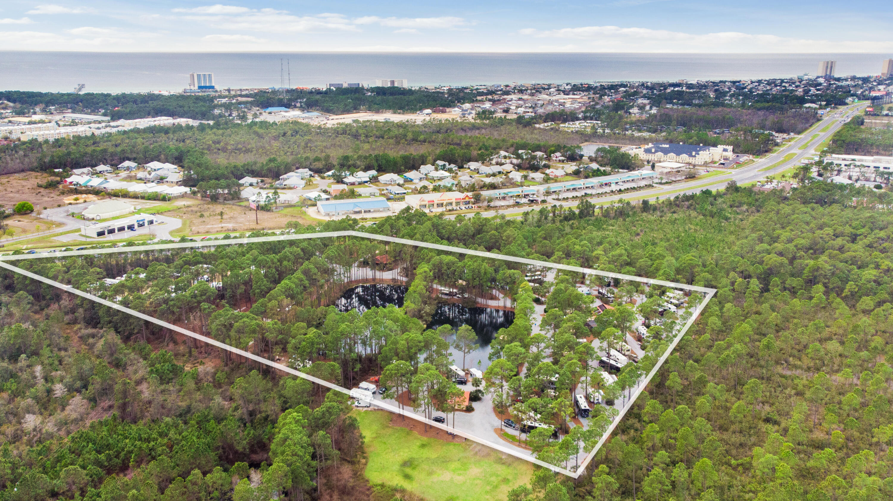 PRIME LOCATION! Pineglen Motorcoach & RV Park boasts 13.8 acres with close to 6 acres of commercial development opportunity along the 830ft of frontage on Panama City Beach Pkwy that is slated to expand from four to six lanes per FL DOT. Positioned along the Beaches corridor that Panama City Beach is known for, this opportunity won't last! Just over 1 mile to the World's Most Beautiful Beaches and minutes from Pier Park offering the best shopping, entertainment and family fun as well as Frank Brown Park and Aquatic Center. Panama City Beach Sports Complex is 2.8 miles east and new large developments are going up all over the neighboring areas. 
All info is deemed accurate but not guaranteed. Buyer is personally responsible for verifying all information. for verifying all information prior to close.