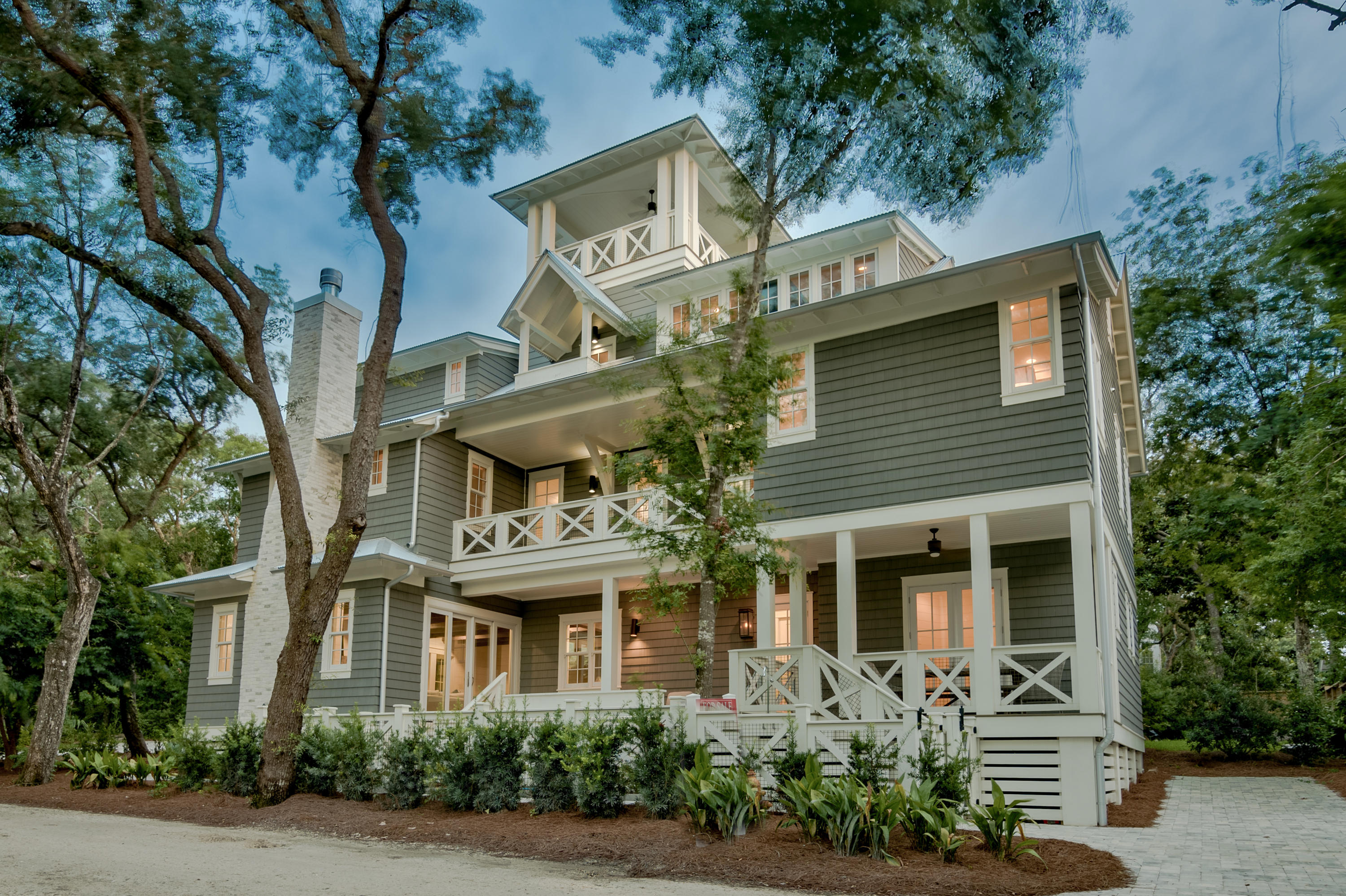 Primely located in the heart of Seagrove Beach, this finely appointed newly built 30A retreat offers a nostalgic coastal lifestyle with juxtaposition of beautiful oak groves highlighted by ample privacy yet perfectly positioned just a few blocks from Seaside and steps to premier beach access. This six bedroom six and a half bath custom-built home is characterized by esteemed architectural elements completed by R.W. Lowe anchored by an exceptional open floorplan specifically designed for legacy living and optimizing entertaining space. Notable features include two master bedrooms, a spacious outdoor living area with heated  resort style pool, private elevator, first floor chef's kitchen complete with leathered marble countertops, stainless Thermador appliances including a gas range and custom hood vent as well as ample cabinetry and an oversized central island. The first level is anchored by a spacious open living room accentuated by coastal reclaimed hardwood beams and flooring as well as a gas fireplace all of which is open to the dining room, kitchen area and outdoor living space. Special attention to detail was taken in curating the designer furnishings throughout the home which cater to both primary and secondary living. This layout was designed to maximize functionality including short term rental opportunity with $185,000-$195,000 in gross projected annual rental income. Modern luxury without sacrificing any of the charm or character of Old Seagrove will make you fall in love with this coastal living retreat. With easy beach access at the end of Live Oak St. as well as gulf views, no HOA and only 4 blocks from Seaside, this home is an exceptional value. Old Seagrove is located in the heart of scenic highway 30A within excellent proximity of world class shopping, dining and entertainment as well as the beautiful white sand beaches and emerald green waters that South Walton County is notable for.