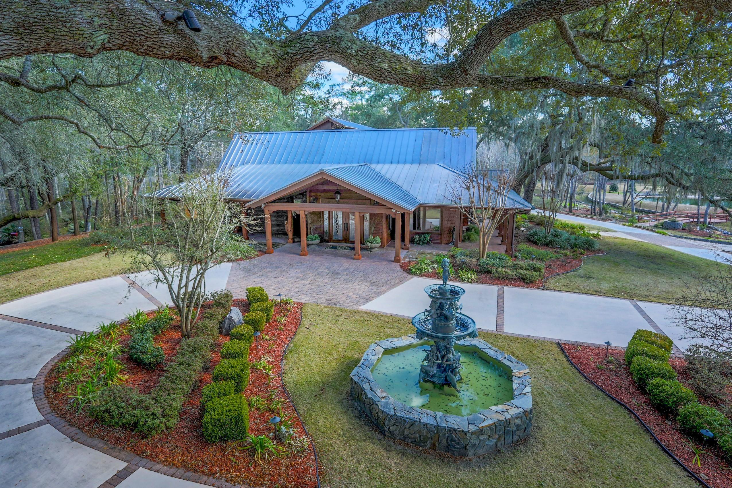 Find your own piece of paradise at this very special estate and ranch known as Phalti. An exquisite main house and separate bunk house are set on nearly 39 acres of natural beauty, including irrigated pasture land, lake/pond, mature trees, and creek access leading to Alaqua Bayou and the Choctawhatchee Bay (navigable by small boat)!
There are many options for entertaining your guests: a large bar area near the wine cellar and formal dining room, a living room with fireplace adjacent to the grand gourmet kitchen, plus a huge family rec room/pool room with gorgeous pool/spa/waterfall, summer kitchen, billiards, large stone fireplace, and so much moreall underroof for year-round enjoyment! An extensive renovation to the main house in 2005 enhanced the quality construction and stunning attention to detail of the original homestead. The finishes include polished stone floors, wood plank ceilings, leaded glass interior doors, a fabulous wine "cellar," granite and onyx countertops, etc. Additional recent renovations include gorgeous mahogany doors and automatic screens in the main house pool area; improvements to the fencing, gates and exterior lighting; landscaping, and more!

The property includes a large detached garage with room for an R/V or boat, as well as golf carts to access the full acreage, and an equipment warehouse for tractors and other maintenance equipment.

Lovingly maintained for many years by the current owners, this property is ready for a new family that wants to enjoy its gorgeous setting and natural way of life!