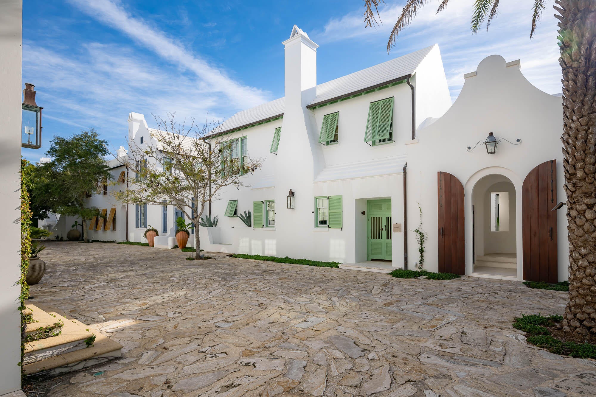 The Sea awaits with the offering of 23 Governors Court situated on the iconic Sea Garden Walk pedestrian path leading to the Gulf of Mexico.  ''Santigua'' as this home was formerly known was Alys Beach's original statement home.  Architect Gary Justiss created this masterful design embodying the original Alys Beach palette inscribed by the Bermudan & Antigua, Guatemalan architecture.

Entering the courtyard lends itself to utter serenity accented by the grotto swimming pool and lone palm tree standing above the vibrant landscape.  Outdoor privacy integrates with indoor connecting the spaces by way of covered loggias for afternoon cocktails poolside.  

The first floor encapsulates one's living needs having interconnected kitchen, dining, and living rooms boasting custom "reeded" Oak cabinetry, concrete counters on both beverage center & kitchen tops.  Wolf & Sub-Zero appliances complement the tasteful kitchen.  Each of these spaces share the timeless views of the beautiful courtyard.

The primary bedroom suite is an oasis within itself strategically designed into the first floor for ease of accommodation.  This bedroom looks upon and has direct access via Loewen French doors to the courtyard.  Flooring is imported Dominican Shellstone carried into the primary suite's bathroom.  The arched bathtub grotto creates a very peaceful, spa-like environment.  Separate closets host each partner welcomed by wormy Oak doors, stained.  

Guests will not be overlooked as each of the three 2nd floor suites host ensuite bathrooms of which one of the guest suites is detached, perfect for extended stay guests.  Stained Oak floors compliment each room.  In addition to the home's amenities, is the 2nd floor den that opens to a roof terrace optimal for sunset gatherings and star gazing.

This home provides ultimate livability and will satisfy the most design savvy.  Please contact me for a private showing.