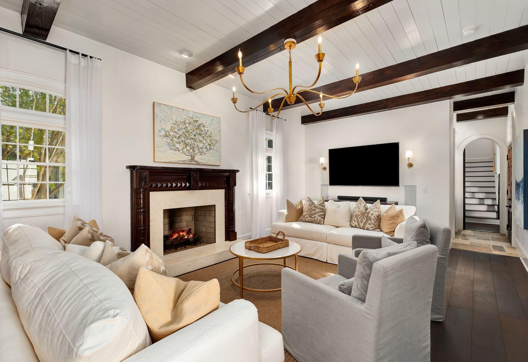 Set behind solid wood gates and backing onto green space, this Colonial-style home is brimming with bespoke architectural features and enjoys the ultimate privacy. Designed by Charrette Design Group, it comes with a separate detached guest cottage for visitors or staff. Parking for up to six cars makes it attractive to investors looking for a premier vacation home satisfying multiple rental profiles. However, you might decide to keep the updated main house for yourself and just rent out the guest house, or vice versa. Everything about this home is exceptional, from the refinished mahogany doors to the updated furnishings and carefully curated artwork. Gleaming with new light fixtures and fresh paint inside and out, the entire home includes Sonos surround sound. Enjoy your favorite playlist whether you're cooking up a feast or relaxing by the black-bottom pool. The grand foyer leads into a huge open living space with a beamed ceiling adding character to this state-of-the-art home. A center island and a separate breakfast bar create a practical space for socializing, entertaining and food prep. Antique French limestone flooring transitions into wood as you move into the cozy sitting room with Isokern fireplace and custom mantel. Darkwood features provide a sense of history and continuity in the formal dining room with its medieval-style candelabra suspended from the timber-clad ceiling. Seven gorgeous bedrooms include a master suite in its own wing. It includes a bright sitting area and a private balcony. The separate guest house has its own full kitchen, laundry and well-appointed living space. A spiral staircase leads up to the second-floor bedroom and bunk room. The porch affords quiet space for reading and relaxing. Outdoor living is a must in the beautiful enclosed courtyard with an L-shaped pool, water feature and gas/woodburning fireplace. The wraparound porch provides a delightful space for dining and entertaining in all seasons. Located in Rosemary Beach, this superior residence is within easy reach of upscale dining, boutique shopping and the renowned white sandy beach.