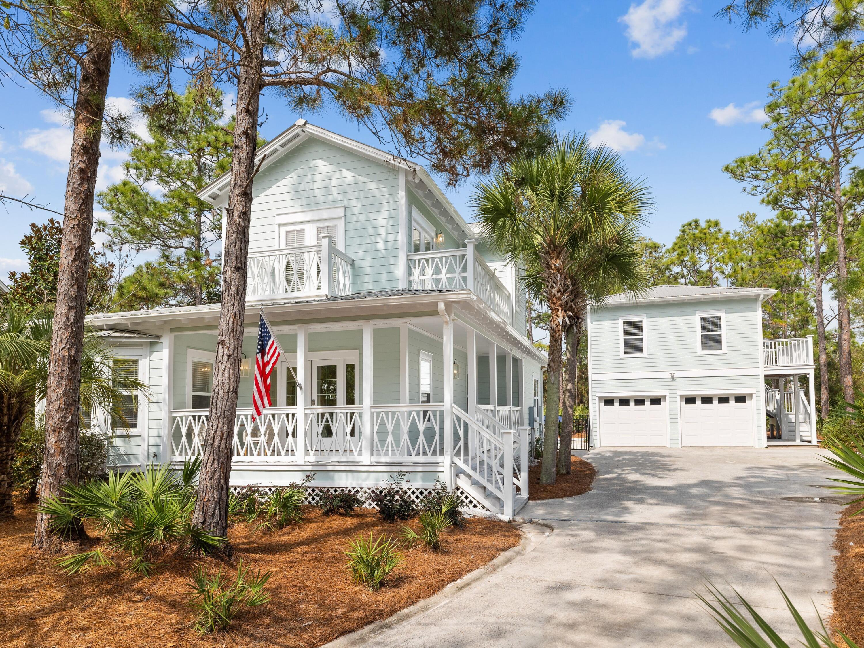 Newly remodeled, this lovely home exemplifies the perfect balance between comfort and luxury. This stunning coastal property with its covered porch and multiple balconies shares a generous quarter-acre lot with a two-car garage and guest quarters above. The open floor plan is a bright and airy space for dining and relaxing with beautiful hardwood flooring. Chefs will be keen to check out the redesigned gourmet kitchen which comes with gleaming white appliances and sleek quartz counters. The island is boldly clad in veined quartz providing a central hub for the apron sink and dishwasher.  The dining table sits in its own bright nook beneath a feature pendant light. After dinner, move into the sitting area and put your feet up in front of the TV. Also on the first floor, there's an adorable bunk room and a guest bedroom. Upstairs, the primary bedroom is a serene space with beam accents drawing the eye upward to the shiplap ceiling. Natural light pours through the doors to bathe the entire room in bright light. The private balcony provides an additional feature. The pristine spa-like master bath has separate vanities and a large walk-in shower. There's also a second sitting area/TV den, which could be used as an office with shared access to the primary bathroom. Guests have their own independent quarters in the carriage house, which has a comfy sitting area, bedroom, bathroom and full kitchen.  An oversized backyard is a cool oasis with lounge chairs arranged around the newly added heated pool. Close to public beach access and Seagrove Beach amenities, this is a very desirable home for those requiring a little more space.