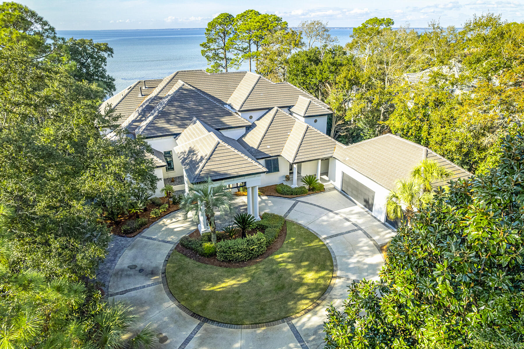 An extraordinary 1.5 acres and 104' of irreplaceable frontage on the Choctawhatchee Bay awaits you here in the private Burnt Pine neighborhood of Sandestin Golf and Beach Resort. With westerly sunset views, it's no wonder the original developer custom subdivided this exclusive Bayfront lot for his own use. The home features a winding drive with mature landscaping as you approach.  

The current owner's passion for design transformed this home into a handcrafted masterpiece with Industrial Minimalist features. As you arrive through the elegant porte-cochere, the tall steel and glass entry doors open to huge cypress beams and columns holding lengthy cold rolled steel wrapped supports. Other steel features can be seen in the dropped kitchen ceiling with recessed lighting, the large... kitchen hood and the floor to ceiling steel and concrete fireplace. The wide flow throughout the spaces display warm 7" wide plank flooring and more black steel doors containing impact-resistant glass, which open to the bay. Other features include a new concrete tile roof, a stackable washer and dryer located in the master closet and the laundry room, an expansive screened lanai with tongue and groove ceiling and Big Ass Fans (manufacturer), all new HVAC units, Generac whole house generator, freshly sodded and fenced back yard, and new pool (heated) and hot tub equipment and accent tile.

The kitchen is equipped with Thermador appliances, including a gas range with steaming capability, warming drawer and an abundance of counter and cabinet space. An antiqued limestone tile backsplash extends to the ceiling. The expansive master suite features a linear fireplace and gorgeous views of the bay. The master bath includes a large shower, Japanese soaking tub and walk in closet with stacking washer and dryer. The living space is almost entirely on one level with guest bedrooms separated from the master. A large bonus space upstairs with a full bath can be used as an extra bedroom, studio or office.

The dock has a boat lift with two additional lifts for jet skis, kayaks or canoes. The three-car garage is equipped with an electric car charger.

The world class nature of this resort and its broad array of amenities, including numerous golf courses, a tennis center, marina, Baytowne Wharf and the beach club is accessible by golf cart which is included with the home. In addition, you can easily reach Grand Boulevard with its many shops, restaurants, a grocery store, and Sacred Heart Hospital by golf cart without even having to travel on Highway 98. The resort offers nature trails at Jolee Island and plenty of green space and multi-use trails for walkers and runners. Please inquire for further details and to schedule a private showing.