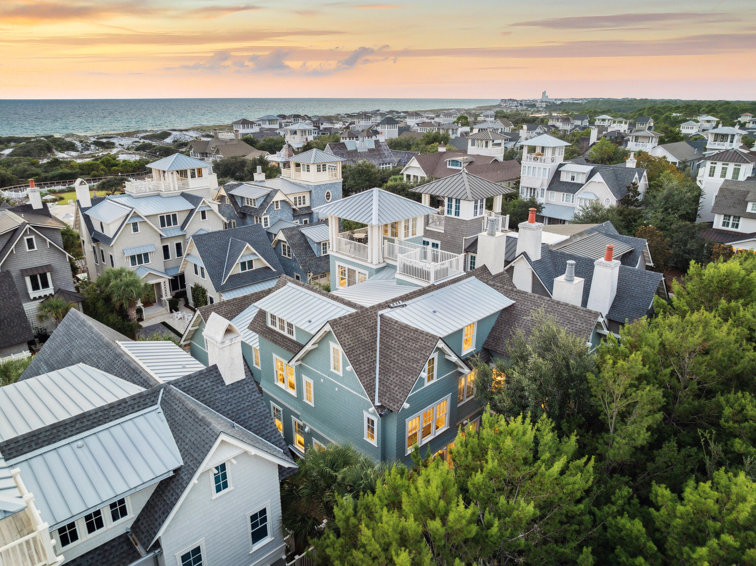 Welcome to 27 Compass Rose Way in WaterSound Beach, an elegant coastal retreat offering six bedrooms, six and a half bathrooms, and over 5,200 square feet of thoughtfully designed living space. Built in 2018, this residence blends timeless design with refined finishes, capturing spectacular Gulf views from multiple levels and a panoramic perspective from the fourth-floor rooftop deck.

The first floor features an open living and dining area anchored by a fireplace, a chef's kitchen with premium appliances, and a guest suite with private bath. Expansive glass doors connect to a private outdoor oasis with a pool, spa, sun decks, and screened porches, including a summer kitchen and additional fireplace. The second floor offers dual primary suites with Gulf views along with two additional guest bedrooms, each with en suite baths. Upstairs, the third level includes bunk accommodations, a game and media room, a reading nook, and office space, while the top floor is dedicated to a rooftop lounge with breathtaking views of the coastline.

Interior details include hardwood floors, multiple fireplaces, wet bars, and designer finishes throughout. Offered fully furnished, the home also provides practical luxuries such as a golf cart garage, ample parking, and generous storage.

Located within the gated community of WaterSound Beach, residents enjoy privacy, deeded beach access, multiple pools, a fitness center, and miles of scenic boardwalks winding through protected dunes. Just steps from the shoreline, this residence embodies the luxury, comfort, and coastal charm that define life along Scenic 30A.
