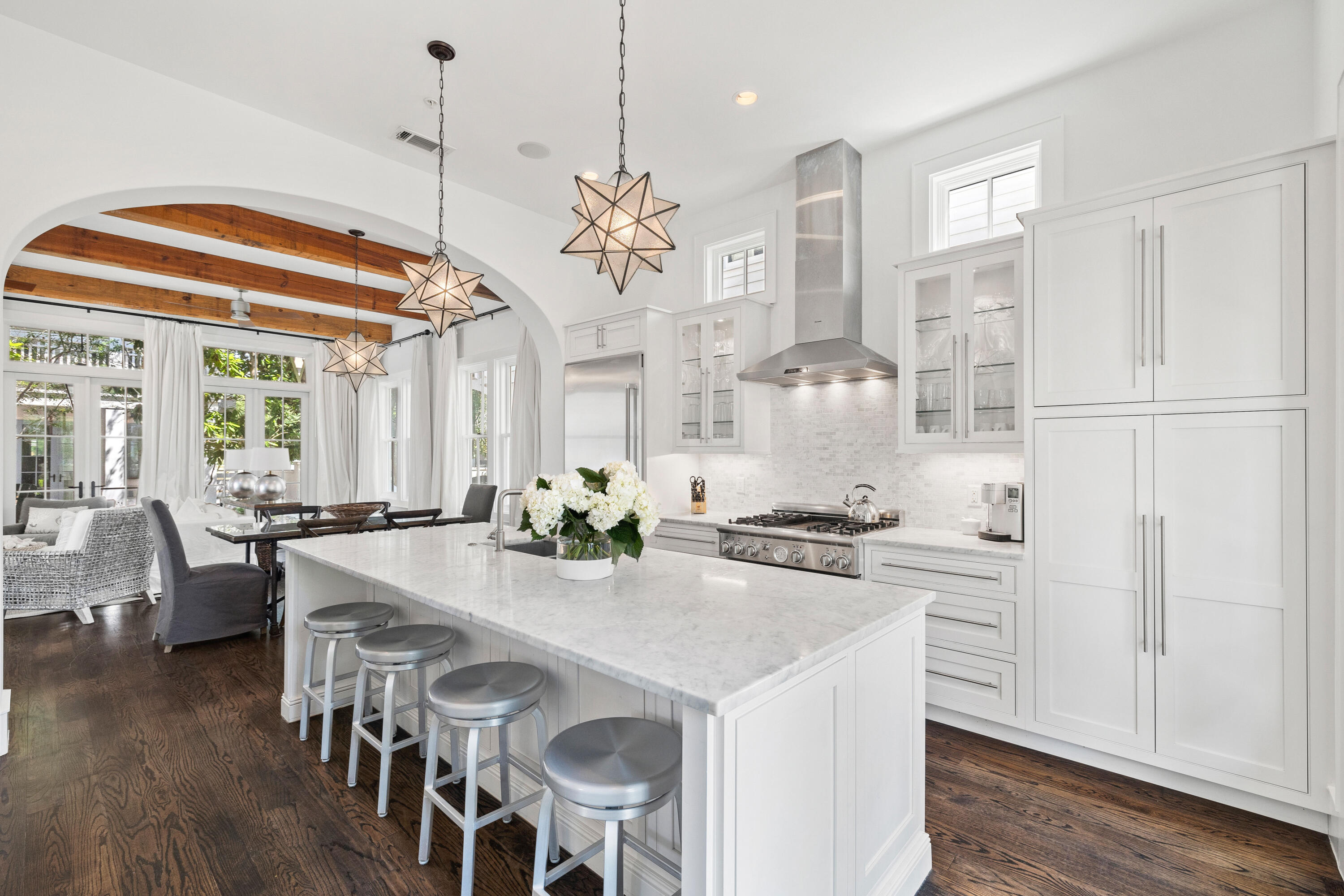 Brimming with charm, this delightful beach cottage sits on a quiet boardwalk within the sought-after community of Rosemary Beach. Designed by renowned architect Ron Domin, it exudes laidback beach-style living with all the attractions of Rosemary Beach at the doorstep. Thoughtful touches include a powder room with an exterior door leading to an outdoor shower for rinsing sandy feet. Inside, this impeccable home combines quality finishes with original design features throughout the open-concept floor plan. Hardwood floors and timber beams add a sense of permanence to the pristine living space. The sitting area is awash with daylight through a plethora of French doors and windows. It creates an alluring ambiance, which continues through an open arch, connecting the dining room with the gourmet kitchen. Stainless steel appliances, a central island and marble countertops provide the necessary inspiration for creating humble snacks or elaborate dinner parties. Dark flooring continues upstairs where three ensuite bedrooms including a spacious bunk room provide guests with home comforts while enjoying the ultimate privacy and convenience. The well-lit master suite is a sanctuary of zen-like calm with its own soaking tub in the well-appointed bathroom. Front and rear porches on both levels provide quiet areas for relaxing in the breeze or socializing with friends and neighbors. There's a paved terrace and parking for two cars in dappled shade to the rear of the property. Those looking for an active lifestyle close to the beach will not be disappointed. Rosemary Beach Fitness Center is fully equipped for a workout while bike and walking trails encourage you to explore the surrounding area. Boutique shopping, high-end dining and live entertainment will all find their way onto your social calendar when you live in this exclusive master-planned community.