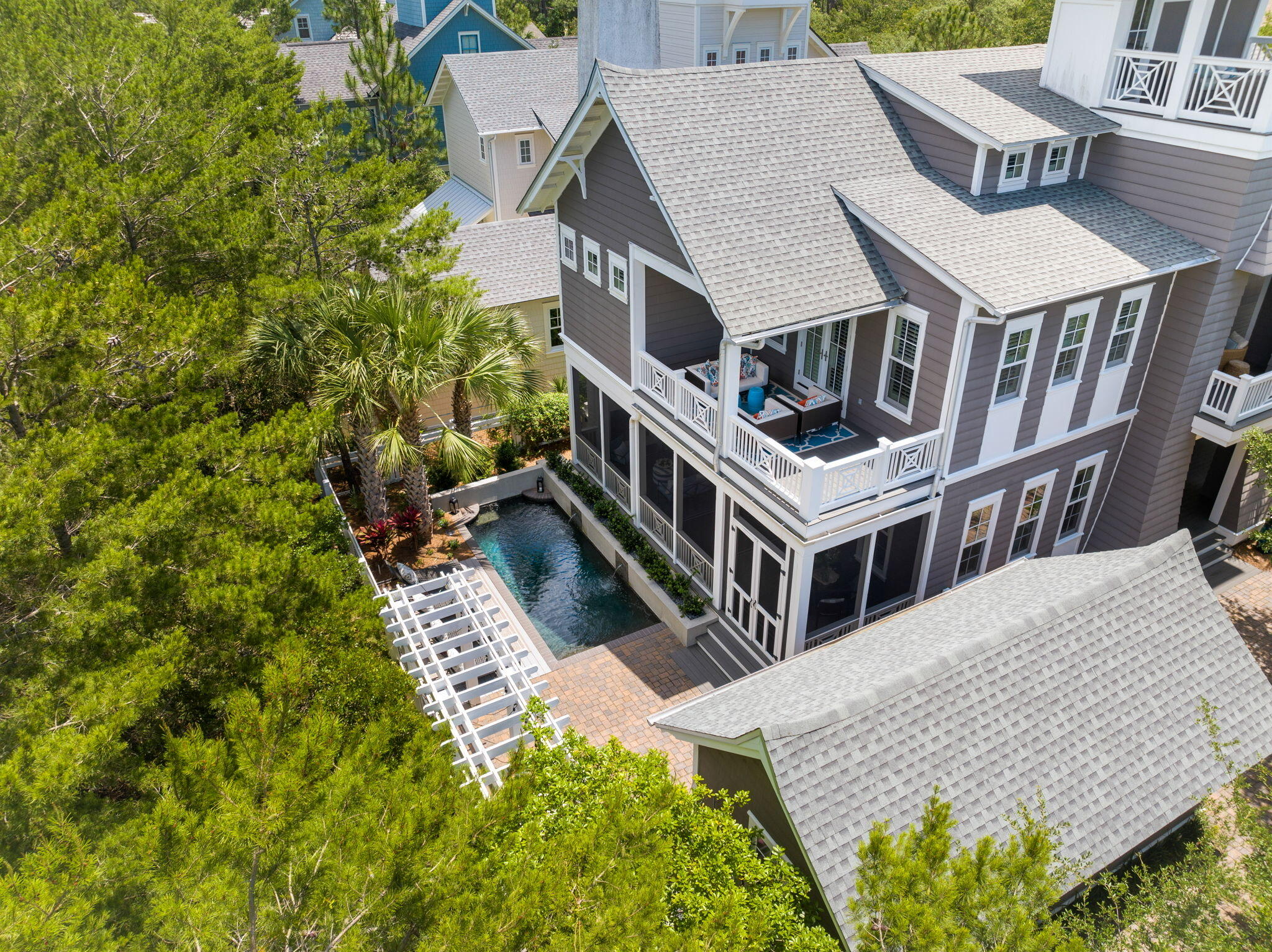 $200,000 PRICE REDUCTION!! Nestled within the prestigious gated Watersound Bridges community this captivating 5-bedroom, 4 ½-bathroom residence, complete with an office, offers almost 3700 sq ft of thoughtfully crafted living space. Step into the expansive kitchen overlooking the inviting living and dining areas with charming shiplap accents. Outside, discover a screened porch boasting a cozy fireplace, complemented by an outdoor summer  kitchen and a welcoming heated pool—creating an idyllic setting for hosting gatherings and creating cherished memories.
Inside, find dual primary bedrooms, one conveniently located on the first floor, in addition to a versatile bunk room and two additional guest bedrooms. Ascend to the third level to savor breathtaking Gulf and serene lake views from the open tower.