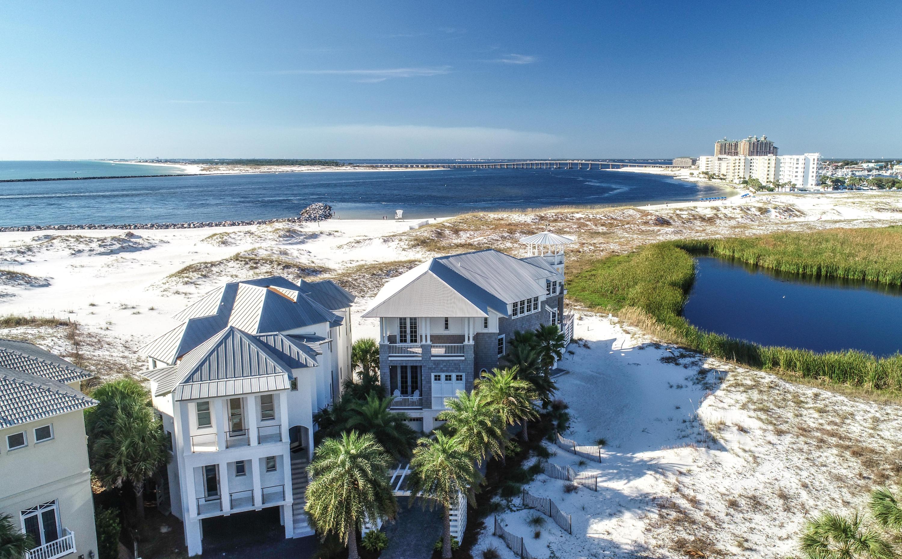 This Gulf front and Lake front, Savoie design, fully furnished, custom home with Professional Interior Design by Beau Interiors, is the most unique home on the entire Emerald Coast. Situated in a Gated Community, on 'The Point' and facing west/southwest, every room in the house faces the Gulf, with deck access, to take advantage of spectacular Gulf sunsets 365 days per year. On the shores of a Coastal Dune Lake, enjoy migratory birds and wildlife year-round. Watch the Destin Fishing Fleet heading to sea and returning home with a sunset backdrop. Completed in 2018 and built above and beyond Dade County codes, with steel beam construction, this Coastal Chic home is built for outdoor living, offering almost 2,000 sq. ft. of deck space, (1,300 sq. ft under roof), an Infinity pool with fire pit and a spectacular 4 story
tower with views of the Gulf, Pass, Okaloosa Island, Crab Island, weekly Summer fireworks, Marler bridge and the night lights of Destin. A mere Â½ mile from the Harbor boat docks, a dock for a 60 ft. boat is available. If you are looking for beach front, yet want privacy, enjoy approximately 200 acres of pristine, sugar white, sand dunes in your backyard. Lush landscaping, Reclaimed Barnwood Oak floors, Professional kitchen, Elevator, Pecky Cypress beams and vaulted ceilings are just a few of the touches that went into the creation of this Gulf front masterpiece. The 6-car garage offers plenty of storage. Featured in VIP Magazine, a home this unique does not come along often.