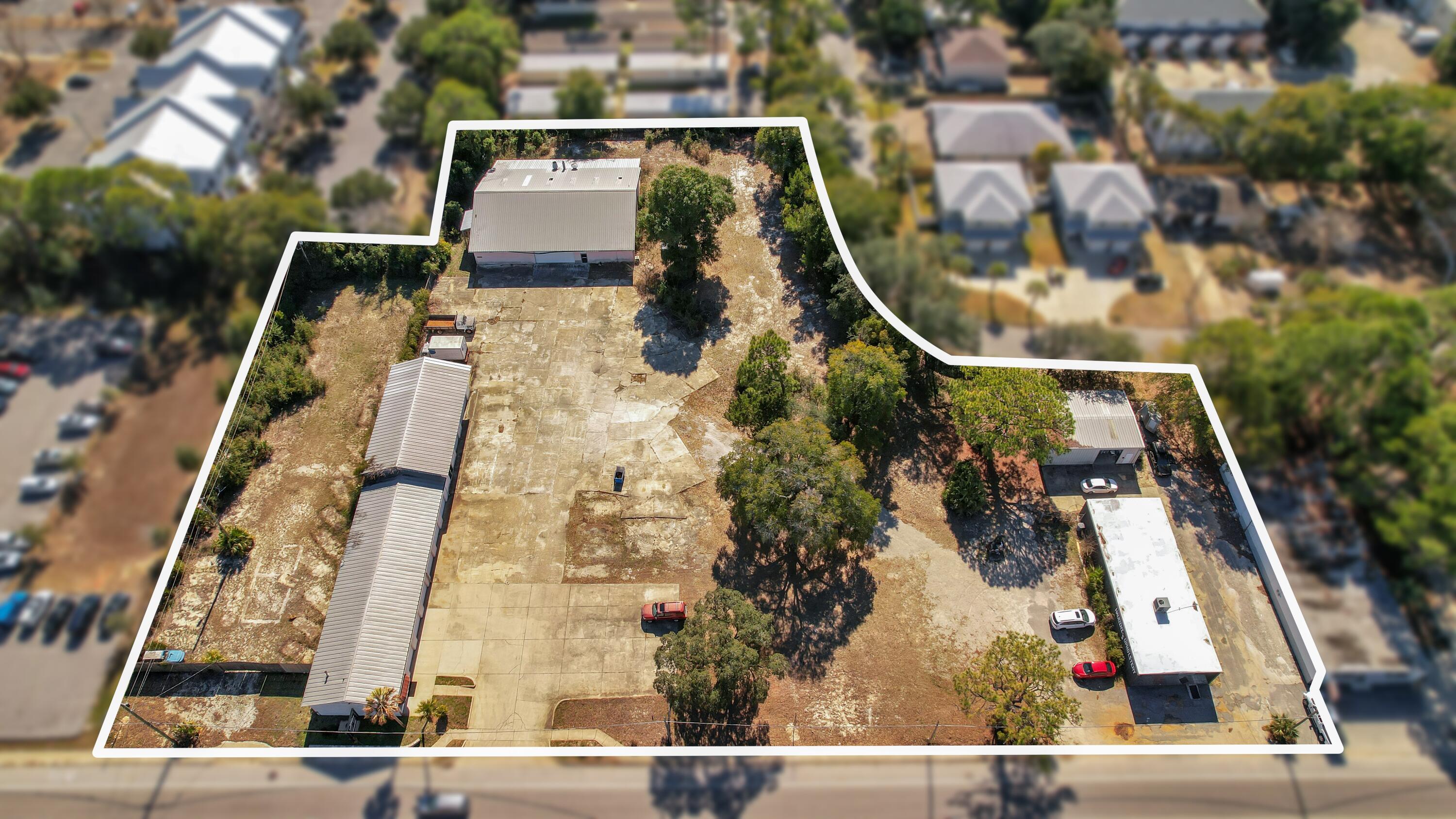 Presented for your consideration is this rare legacy property assemblage consisting of seven combined parcels located at 16 and 20 Hollywood Boulevard in the southeast area of Fort Walton Beach, Florida, totaling approximately 2.76 acres with over 429 feet of frontage along Hollywood Blvd and additional rear access from Park Cir/Park Pl. The site is strategically positioned less than one mile from U.S. Highway 98 and approximately one-third of a mile from Eglin Parkway's primary commercial corridor, providing excellent visibility and access. Improvements include four buildings totaling approximately 13,513 square feet, featuring multiple auto service bays, storefront/shop space, warehouse and storage buildings, lobby and office areas, and a large privacy-fenced laydown yard of approximately .41 acres, ideal for outside storage or parking. Zoned MX-2 (Mixed-Use High), the property has supported long-standing local businesses for decades; the former Tona's Auto Center facilities are now vacant, while Haudini Upholstery remains in operation. The assemblage is well-suited for an owner-user seeking to occupy a portion of the property while benefiting from in-place rental income from the remaining leased buildings, offering a compelling combination of operational scale, income generation, and future redevelopment potential within a high-demand corridor.