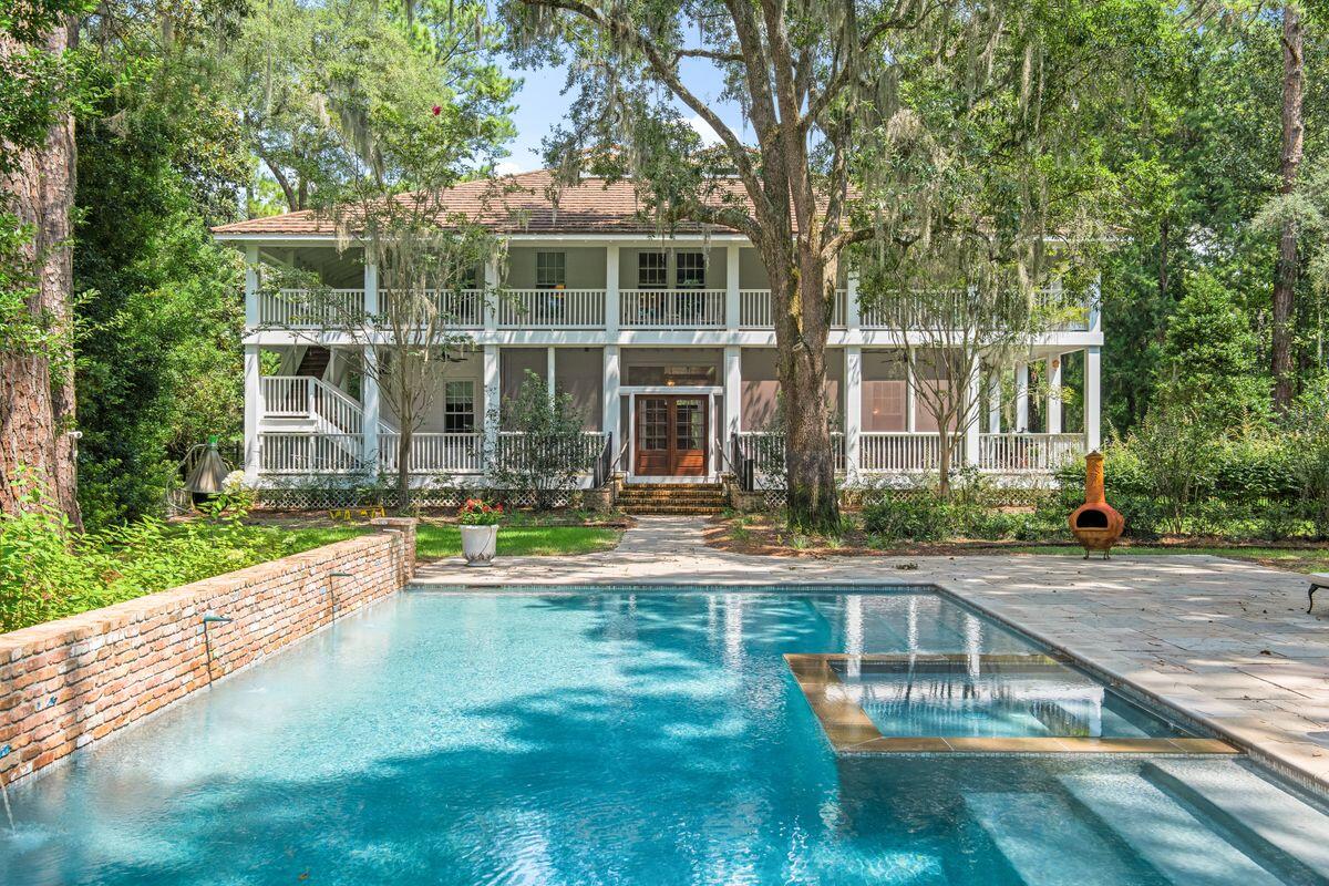 This fully restored Southern-style home is perfect for those who appreciate it's history and heritage. The home sits on more than an acre of lush private gardens featuring giant Southern magnolia trees, mature live oaks, long-leaf pines and other native trees. The lush private backyard with sandstone walkway features a welcome modern addition; a private heated, lighted pool with a copper fountain water feature and antique Chicago brick backsplash. Deep wraparound porches on both levels provide shady outdoor living space overlooking the peaceful natural surroundings. Welcoming you inside, the mahogany door with brass hardware provides an appropriate entrance to the grand foyer lit by antique sconces and a chandelier. Original heart pine ceilings and walls grace the spacious rooms throughout this magnificent four-bedroom mansion. Extraordinary Gucci crane wallpaper adds a delightful feature to the formal dining room, lit by an antique chandelier. The living room is a natural hub for extensive family gatherings and holiday celebrations around the carved mahogany fireplace. Custom cabinetry and drapes add to the timeless traditional setting. Walnut cabinetry sets the tone in the magnificent eat-in kitchen, which boasts unlacquered brass hardware, a fire-clay farm sink, and a Rohl pot filler above the La Cornue dual-fuel range. The vast center island has Alabama Rose marble countertops and provides seating for informal family meals. Shiplap walls and a cushioned window seat add a homey touch. A wet bar, coffee station, icemaker, two wine towers and a fully equipped laundry bring the home into the 21st century. The grand staircase is a natural eyecatcher, leading to four light-filled bedrooms and three bathrooms that feature modern fixtures with an appropriate nod to antiquity. A deep copper tub offers leisurely soaks in the master bathroom, which showcases Carrara marble wainscoting, a double marble vanity and marble checkered flooring. The third-floor attic is ideal for a game room, bonus room or additional storage. 

Dating back to 1895, this remarkable period mansion was built by Simeon Strickland after he constructed the historic Wesley House for his daughter.  The Wesley house is located in the neighboring 163 acre Eden Garden State Park, overlooking Choctawhatchee Bay.  The Strickland house was home to multiple generations of Strickland family descendants, including a daughter who served as the postmistress throughout the 20th century.  The Point Washington post office,  originally a lumber mill office for the Wesley family, dating back to 1936,  is located on the property. It still showcases the postal boxes, but allows flexibility for a new owner to create a special space reflective of their interests. 

Boat lovers will appreciate the proximity to Tucker Bayou, accessed from the nearby Point Washington boat ramp on Highway 395. This beautiful period property deserves to be appreciated and enjoyed as a magnificent legacy family home.