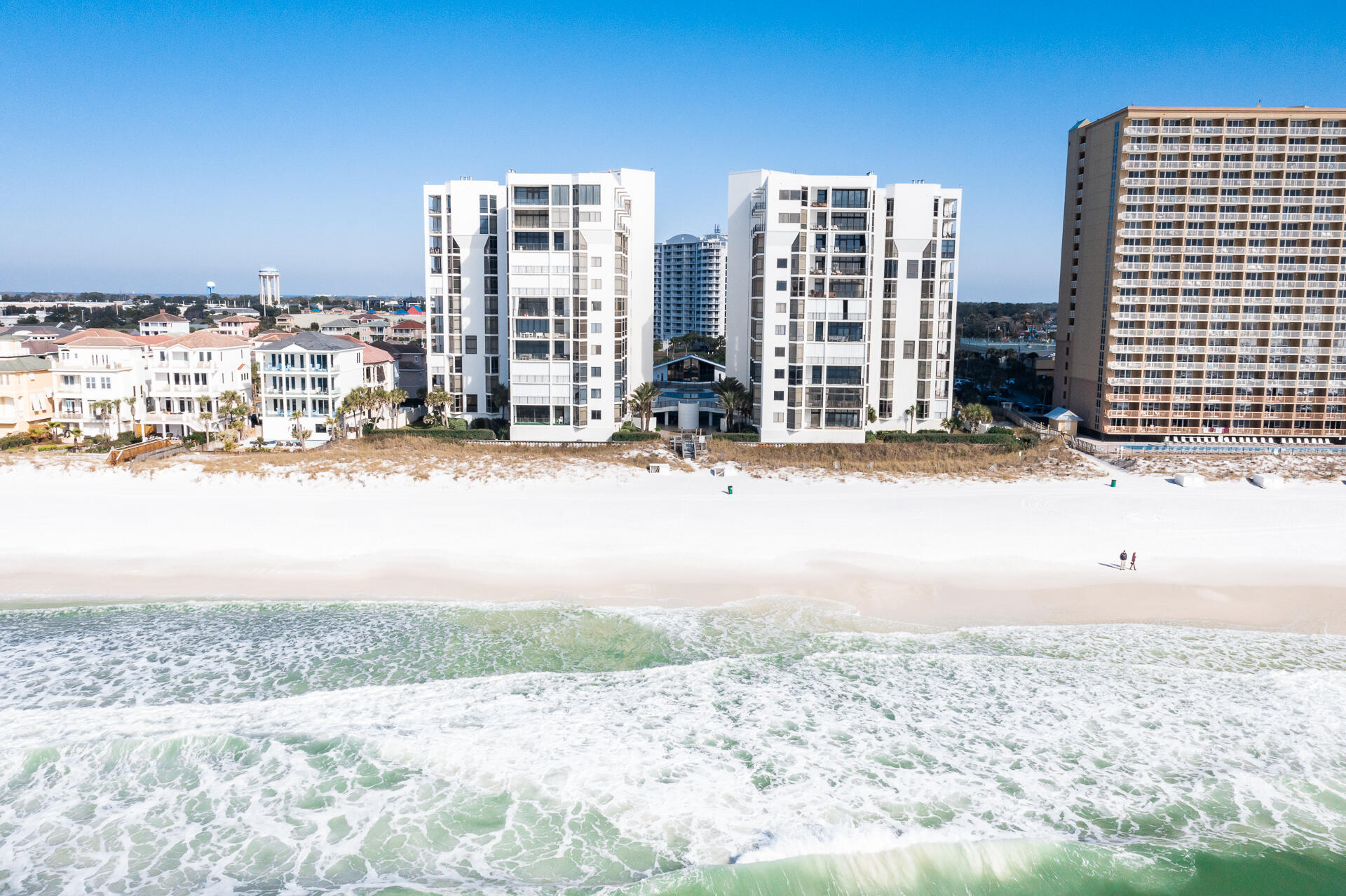 Completely renovated luxury Gulf front condominium in the ultra-private Regency Towers. Behind the gates you will find 44 Gulf front, non-rental condominiums with sweeping views, private deeded beach, Clubhouse, tennis, pool, fitness center, sauna, and onsite Security & HOA Office.  This 7th floor unit with floor to ceiling windows provide breathtaking views of the Gulf from every room! No expense was sparred with the renovation and rebuilding adding new flooring, kitchen & bath cabinetry, countertops, recessed lighting, reconfigured floorplan, wet bar with ice maker & beverage refrigerator, enlarged master closet, expanded laundry room, modern tile in all the bathrooms and outstanding light fixtures. All new appliances along with new HVAC systems. Two units per floor with a shared lobby along with extra storage enclosures for each unit.  This unit has three bedrooms, one with an extra Bunk area all with private ensuites, a half bath off the hall and oversized Gulf front balcony. Square footage per County PA Records.