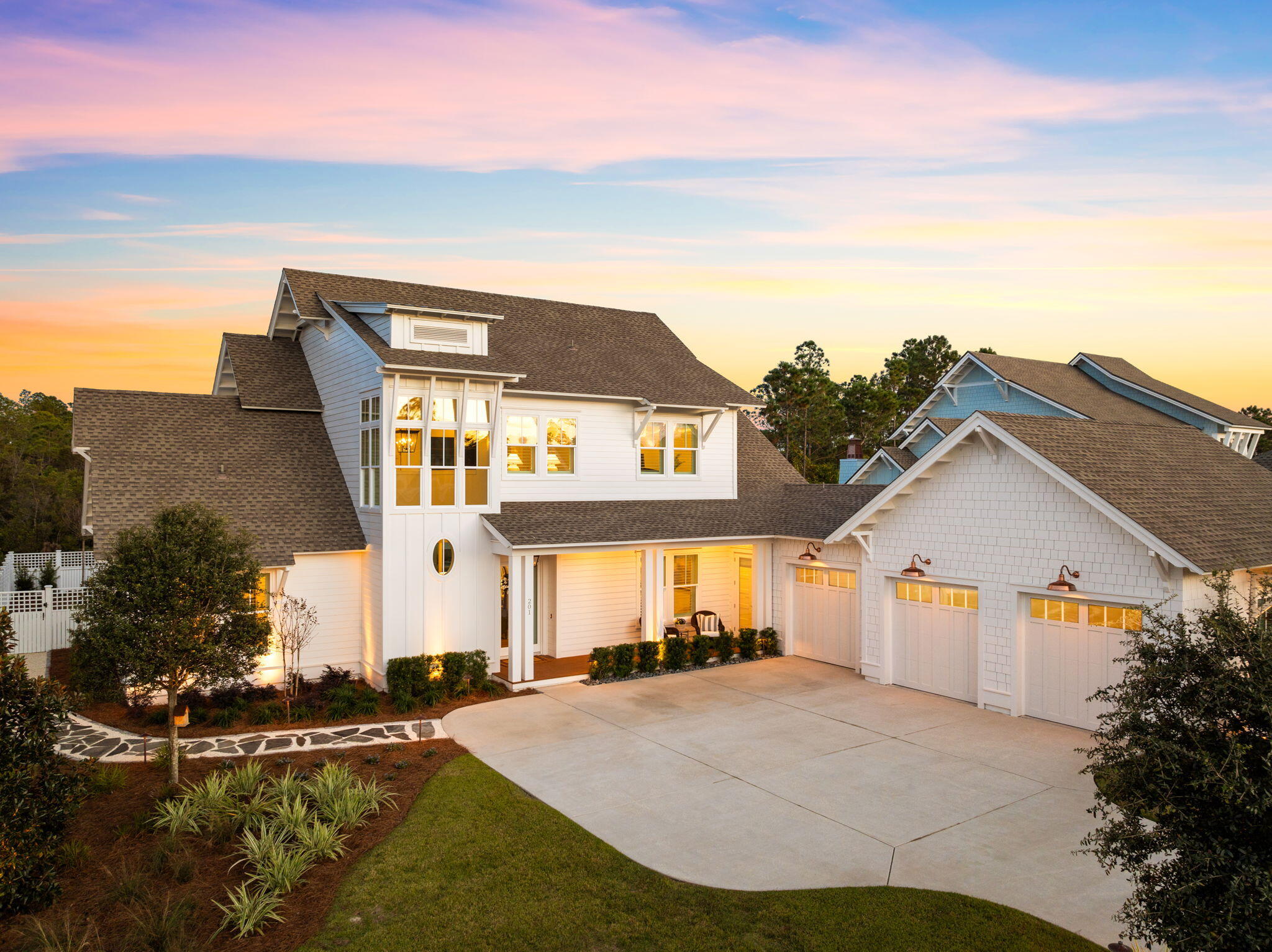 Coastal luxury living is defined at 201 Needle Cast Lane in the exquisite community of Watersound Origins. Situated on a highly enviable homesite of .37 acres, one of the largest in the community, this home borders a large pond and a wooded preserve making it the most desirable tranquil retreat. 

This custom home has nearly 3,500 square feet of living space with 5 bedrooms, 3.5 bathrooms, a large, screened patio with gas fireplace and stunning summer kitchen. This picturesque backyard with a very large, heated pool offers tranquil views of the lake, ample green space, providing a high level of privacy with mature, lush landscaping. Paired with the summer kitchen featuring a gas grill, refrigerator, brick-clad gas fireplace and screens, this outdoor space is designed for relaxation, dining and entertaining. 

Upon approach to this remarkable custom home, you're greeted by Coppersmith true copper gooseneck lights, an architectural showpiece of soaring windows with an impressive tower design, charming covered porch, spacious 3-car garage and developed landscaping. An incredible amount of custom, outdoor landscape lighting has been added to truly make this home standout! As you step through the front door, you'll be greeted by 2-story ceilings and a grand staircase flooding the foyer with natural light. This one-of-a-kind home offers wire-brushed white oak flooring throughout, shiplap gracing the walls and plantation shutters, creating an exceptional transitional design. 

The living room focal point is the white brick-clad fireplace and custom built-ins surrounding the showpiece. Spread open the full glass panel slider doors and create an indoor-outdoor oasis with the oversized screened porch. This porch is where you'll relax year-round with gas grill, refrigerator and summer kitchen with white cabinetry and quartz countertops. Charming drapes have been added for additional privacy and keep this area cozy and warmer on those nights you're enjoying the gas fireplace on. 

Back inside, the home is continuing the theme of being designed for entertaining in mind and you'll find the dining room is just off the living area. This room includes large windows providing natural light, a gorgeous Visual Comfort chandelier and hosts a wet bar, great for the convenience of guests. 

As you move into the kitchen, look up to find a soaring vaulted ceiling accentuated by shiplap, lovely Savoy House island pendants and beautiful custom cabinetry and quartz countertops. The kitchen is a culinary dream equipped with highly desirable appliances including a Viking 48" gas range and Viking paneled refrigerator. Imagine the memories that could be made in this kitchen while you are able to engage with your friends and family at the oversized quartz kitchen island or the charming breakfast nook. Around the corner, you'll find a large walk-in pantry with built-in shelving and a laundry room complete with quartz countertops, sink, custom tile flooring and space for a front-loading washer and dryer. The charming hallway leading to the pantry and laundry has shiplap walls embellish with thoughtful hooks for coats and bags accessible when you're exiting to the 3-car garage at the end of the hallway. 

Moving from the living room to the left side of the home, you'll step into a uniquely-designed barreled archway leading to the powder room, primary suite and an additional bedroom. Having a 5th bedroom on the main level offers a variety of options available to the homeowner such a bedroom for guests or large home office, as the current owners are utilizing it for. Step toward the back of the home and you'll enter a tranquil retreat - the primary suite. This suite was thoughtfully designed with a spacious, custom built closet on the right and a luxurious bathroom on the left. The serene sanctuary features double vanities with a beautiful soaking tub adorned with a transitional, stunning Capital Lighting chandelier and a separate shower with Calacatta marble tile. The primary bedroom is trayed with beamed ceilings and overlooks the lush green back yard and lake while also giving access to the screened porch and pool with a separate, private door. This retreat is a true dream! 

On the upper level of the home, you're greeted with a cozy loft area just off the staircase. This is ideal for an additional hang space or relaxation area, away from the main living. This level features three additional bedrooms and two full bathrooms. With all three additional bedrooms generously sized and the loft area, this level creates a highly functional home while providing separation from the primary suite downstairs. The current homeowners utilize one of the bedrooms as a home gym, which is an amazing amenity to have in the luxury of your own home.  The upper level bathrooms offer both a tiled walk-in shower and a large shower and tub combination with three vanity sinks. 

This remarkable residence is truly exquisite when it comes to upgrades and a thoughtful design. The homeowners have upgraded the home with luxury lighting adding the convenience of dimmer ability, plantation shutters and custom drapery along with many media upgrades. This home offers a whole home internet network including multiple wireless access points, indoors and outdoors, as well as a Sonos audio system complete with soundbars and speakers., indoors and outdoors. This stand-out, custom home is ready to call home. 

Watersound Origins is a community where luxury meets convenience. This community features 1,400 acres, just 1/2 miles to the beaches of 30A, and offers its residents a resort-style pool, fitness center, walking trails, Lake Powell access with complimentary kayaks. Residents also enjoy complimentary use of the Origins Golf Club which features a Davis Love III design of a 6-hole regulation or 10-hole par-3 layout. This community is fast-growing and offers a new Publix grocery store at the entrance along with multiple restaurants, shopping establishments and medical and professional offices. Residents also have the opportunity to join the WaterSound Club, a luxurious private club in South Walton that features multiple amenities such as private beach access with beach service, resort style pools, 12,000 wellness and fitness center, two private golf courses designed by Greg Norman and Tom Fazio, a recently announced third private golf course and the newly opened Lifestyle Center at WaterSound Camp Creek, across from Origins. This is your opportunity to live in true coastal luxury...don't miss it!
