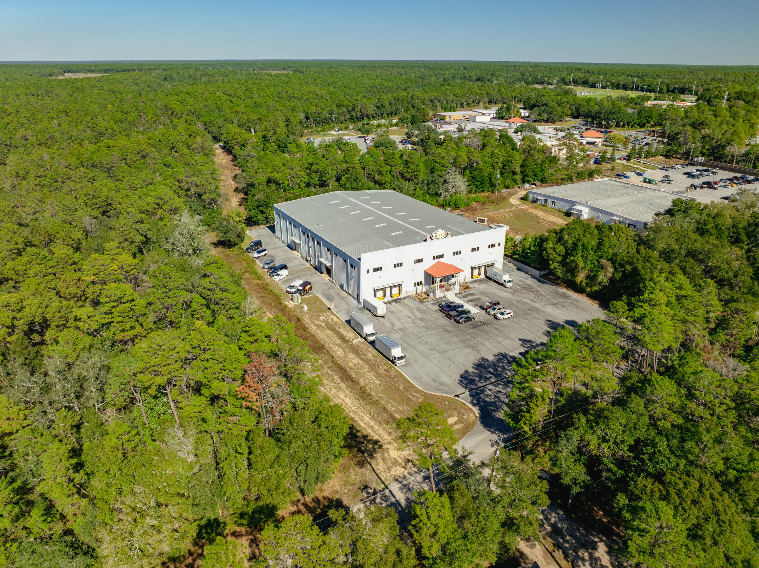 LIST PRICE SIGNIFICANTLY REDUCED! This massive building was constructed in 2008, masterfully designed and engineered, while impeccably maintained. This rare opportunity to acquire such broad scale in the local market offers immediate revenue-producing potential for an end-user, as the design accommodates ingenious versatility throughout, including its workshop, warehouse, showroom, offices, laydown yard, and abundant parking capacity. The 3-story building contains (4) semi-trailer loading docks, (6) ground-level doors, an elevator, and a generator, which backup power provides safeguards involving the IT / server room. The building plans are available via Dropbox upon request. Please inquire to attain further details. Showings require (24)-hour advanced notice, and... , and the listing agent must accompany all showings.
