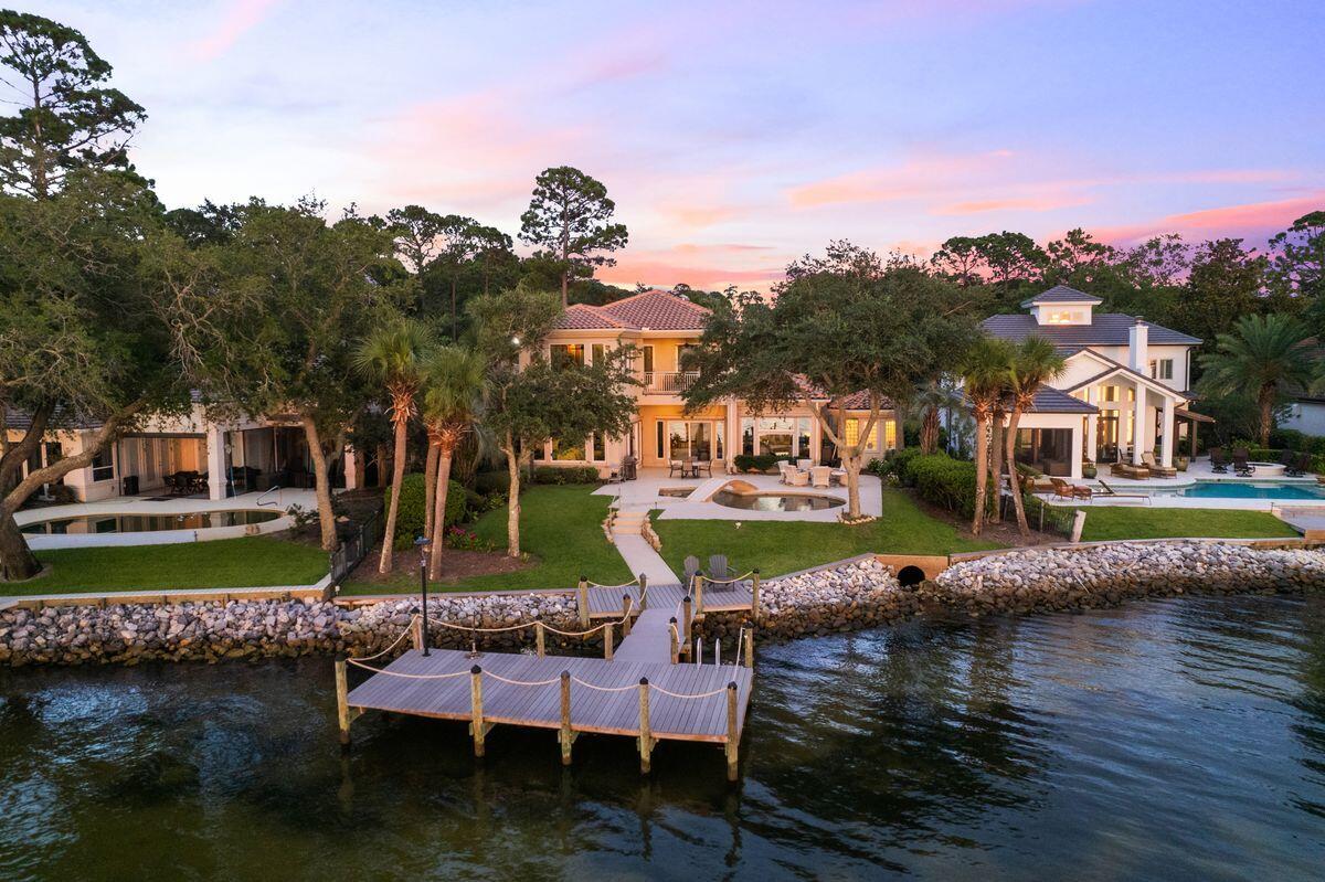 This outstanding bayfront estate is the ideal permanent residence or second home for those who enjoy boating, water sports and sunset vistas. Packed with wonderful design features, it has many luxury amenities including an elevator, remote screens, Lutron lighting and a private Trex dock. The sweeping paved driveway leads to the upgraded garage, golf-cart garage and covered porch entrance. Step inside to admire the expansive open-plan living area with exquisite travertine flooring and streamlined decor. It provides a fresh sunlit space for entertaining, relaxing and enjoying life to the fullest. Doors and windows frame tempting views of the elegant pool, terrace and tranquil bay waters from multiple sitting areas. An eye-catching helix staircase winds upward to the second floor, if you don't want to use the elevator. The generous kitchen with twin islands provides a well-ordered space for serving canapes, cocktails and casual dining. Italian matte leather granite counters, subtle uplighting, a KitchenAid double oven and a butler's pantry complete this well-designed area. The expanded master suite is a self-contained haven with an oversized sitting area and office, perfect for drinking in the breathtaking waterfront views. It's the optimal space to start and end each day. The updated master bath boasts an oversized walk-in glass shower, soaking tub, quartz countertops and an added closet. Four additional guest suites and a theater room complete the outstanding amenities offered by this home. Sandestin is Florida's elite resort, boasting four championship golf courses, a world-class tennis center and 98-slip marina. For true golf cart community living, Grand Boulevard is just a few minutes away, providing access to high-end shopping, restaurants and entertainment.