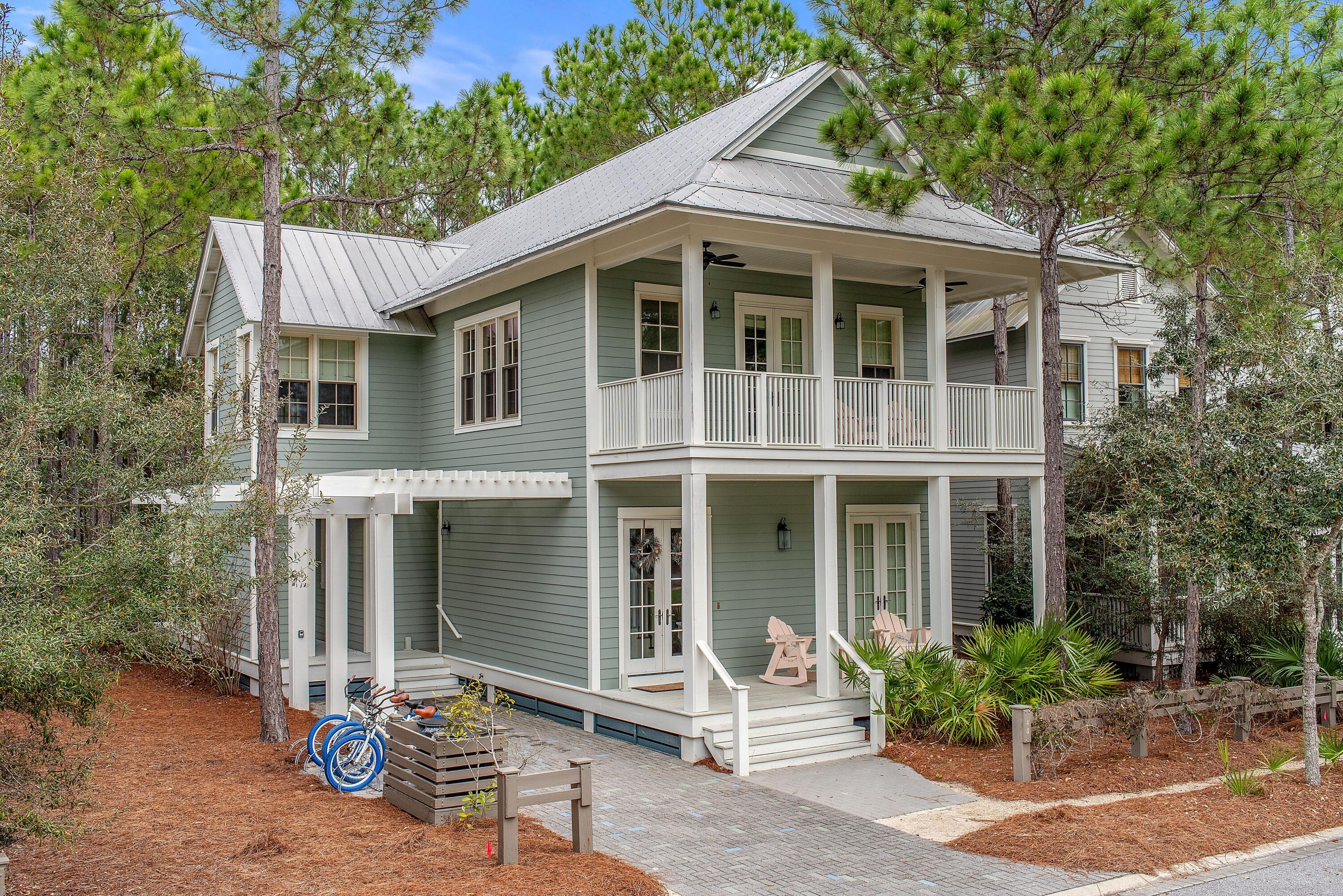 Sitting on a quiet side street this property features 4 bedrooms, 4.5 bathrooms with the beauty of a nature preserve in the backyard and one of Watercolors many parks and Camp WaterColor just steps out the front door this property will allow you to enjoy Watercolor living at its best!  This Beachy property  is adorned with white interiors and neutral wood accents, hardwood floors, coffered ceilings and an open floor plan on the first level make it the perfect space for entertaining guests and enjoying family time.  The kitchen features black granite countertops accented with white cabinetry, and stainless-steel wolf and sub-zero appliances including a gas range. This home has the sought after first floor mini master bedroom with ensuite. The second floor offers the master bedroom an additional guest bedroom and a bunk room which showcases a built-in, three-tiered bunk bed. All bedrooms have their own private ensuite bath and two have access to the porch. This home is on an oversized lot and backs up to a nature preserve, offering peace and tranquility and also has plans approved by the HOA for the addition of a pool. The home offers both a first floor and second floor porches that have both screened and open space. The property is conveniently located a short walk from the newly renovated Camp WaterColor, which offers two large pools, waterslide and a lazy river and is a short bike ride or golf cart ride to the Watercolor Beach Club. The WaterColor community includes both condos and residential homes and is an award-winning beach side resort located on the beautiful Gulf of Mexico beaches and alongside serene Western Lake. The community is designed to have a small-town feel and is perfect for exploring on foot or by bike. Quaint streets and pathways connect homes to the community's parks, lush green spaces and shops. The community includes access to a newly renovated and expanded gulf front beach club, boathouse with paddle boards, kayaks and fishing equipment, an outdoor amphitheater, several pools one which includes a lazy river and waterslides, and a bike barn. Residents have access to a state-of-the-art tennis center, including a stadium court surrounded by a grass-stepped terrace and native landscaping, five Har-Tru HydroCourt clay tennis courts and a pro shop with tennis gear. Private lessons, group clinics and other activities are available throughout the year. This home and beach resort are a must see, call to schedule a showing today!