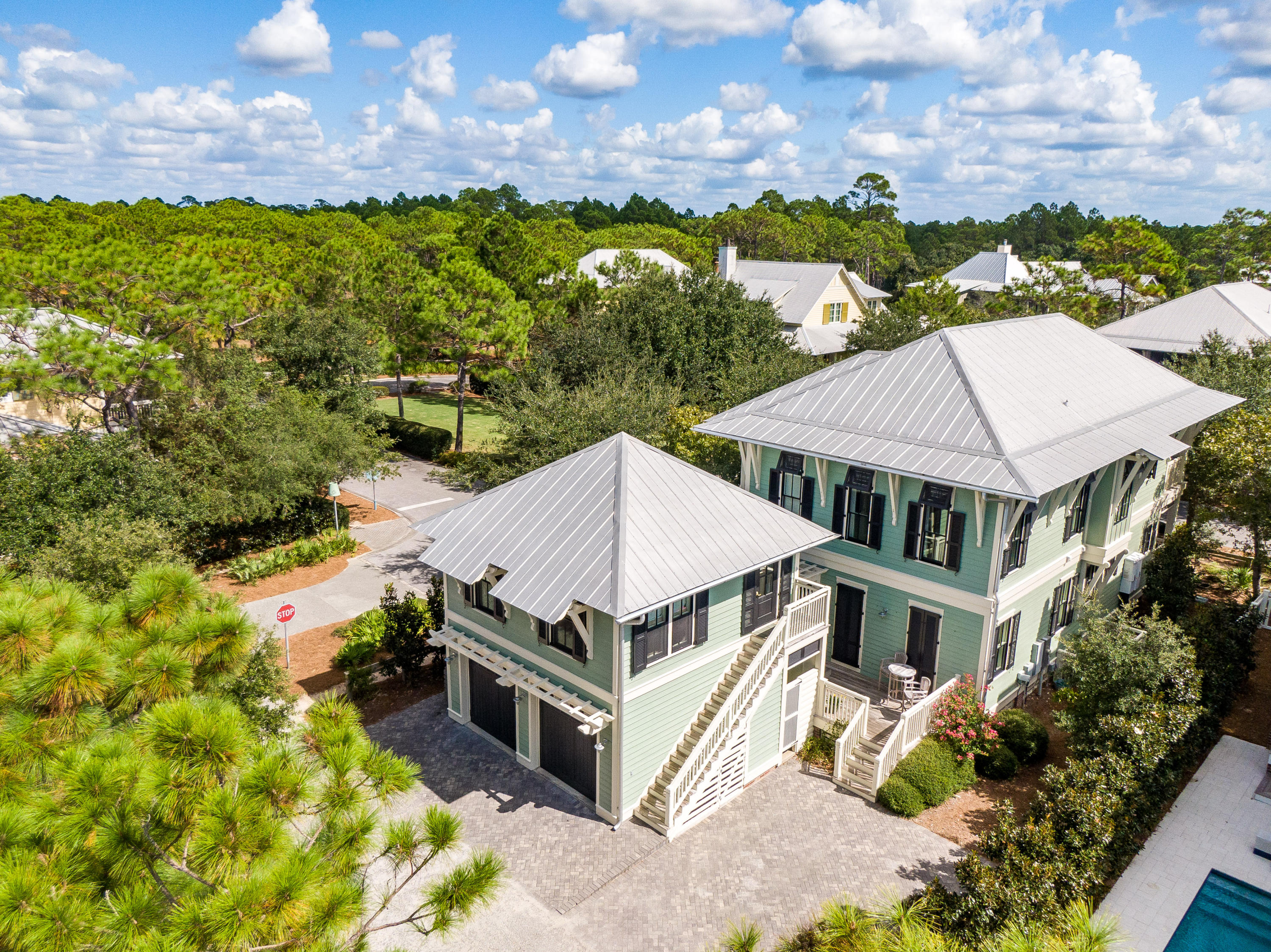 Placed perfectly on a corner lot across from a landscaped park in Watercolor is a shuttered New Orleans Style Home and Carriage House inviting you to come be a part of this quaint Beach Community. Warm, welcoming, and comfortable with casually furnished interiors and 2 floors of screened and wrap around porches this 5 Bedroom-5.5 Bath Home sold furnished can be the second home of your dreams and an excellent vacation rental. It is tucked on a quiet street providing privacy with a park on one side and common area space to the rear. The 2 car garage and a parking pad which accommodates 2 additional cars is more than adequate. The Open Floor Plan with porches everywhere invites friends and family to gather and enjoy all 3OA and our Beaches offer.