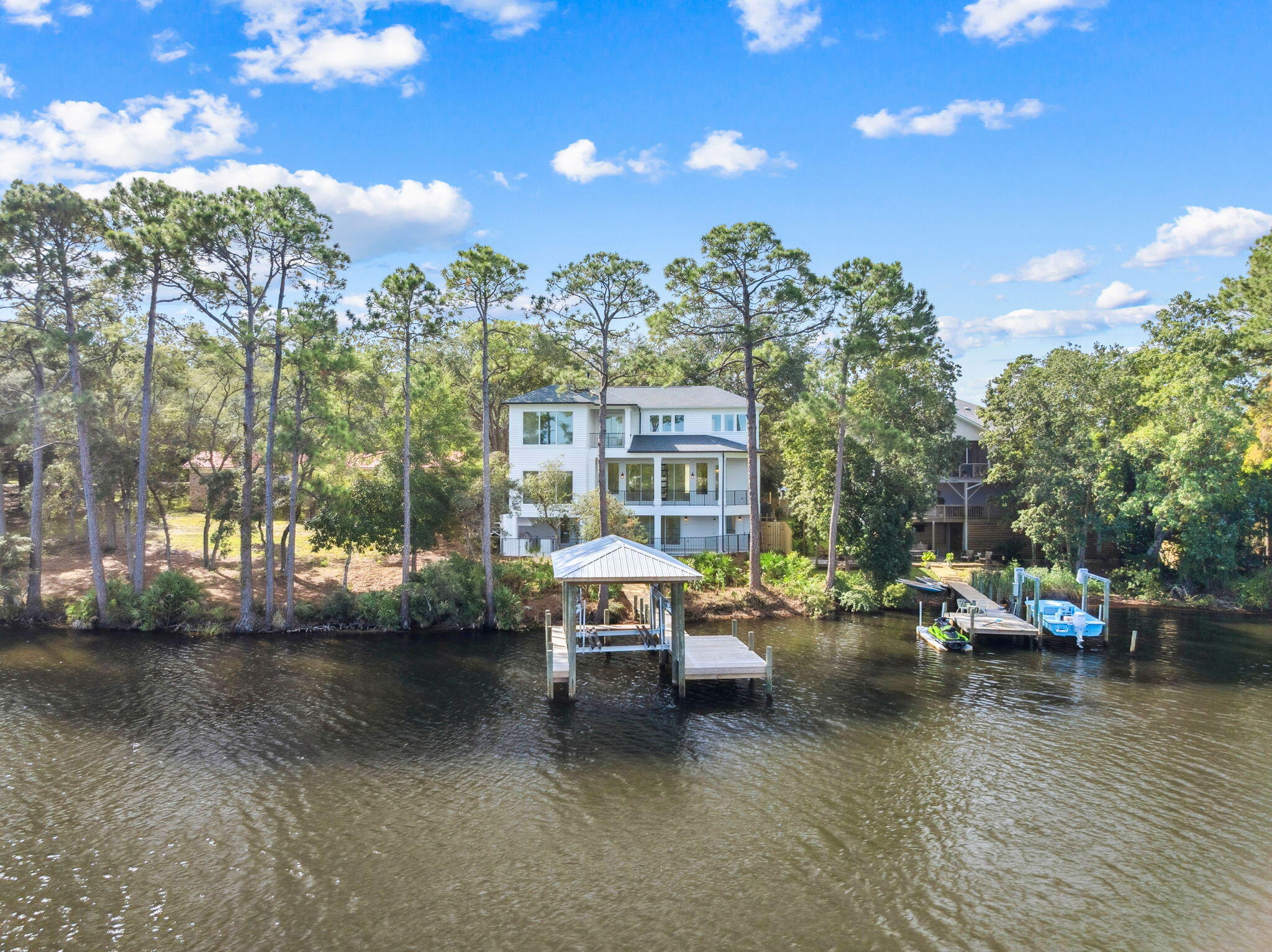 NEW HOME ON LAKE POWELL IN INLET BEACH WITH WATER, WATER, WATER VIEWS EVERYWHERE! Experience extraordinary lakefront living in this stunning 4,432-square-foot, 5 bedroom, 6 bath residence on Lake Powell. Designed with both comfort and entertainment in mind, this home offers a lifestyle unlike any other--where boating to the beach and upscale dining on the east end of the famous highway 30A are all part of your everyday experience. The main level welcomes you with an open concept living, kitchen, and dining area with a master suite, ideal for entertaining while taking in the lake views from the expansive balcony. Downstairs the Lake/Pool level offers a bunk room, a game room, media room, and full bath, perfect for gatherings after a perfect day of boating to the beach. Hardwood and shell stone floors flow seamlessly throughout, adding warmth and elegance to every space. The third floor features an additional master suite, 2 additional bedrooms and 2 bathrooms, each offering serene vistas of the lake and surrounding lush vegetation.
This home has the ability to have an elevator installed in the shaft that is currently being used as closet space on all three floors.
Outdoor living is at its finest here. A sparkling private pool and hot tub, complete with an outdoor kitchen, creates the perfect backdrop for entertaining or relaxing under the Florida sun. From your private dock complete with boat lift, you can launch straight into boating adventures on Lake Powell, the largest coastal dune lake in North America.
Located just moments from 30Avenue, you'll enjoy effortless access to world-class dining at favorites like Amigos and Amici 30A, Cuvee 30A, and Aja Kitchen, along with boutique shopping and local hot spots. The new pedestrian underpass makes reaching the white sandy beaches of the Gulf of Mexico and the charm of Rosemary Beach both easy and convenient.
This home is more than just a residence...it's a lifestyle. A rare opportunity to enjoy the very best of both beach and lake living awaits.