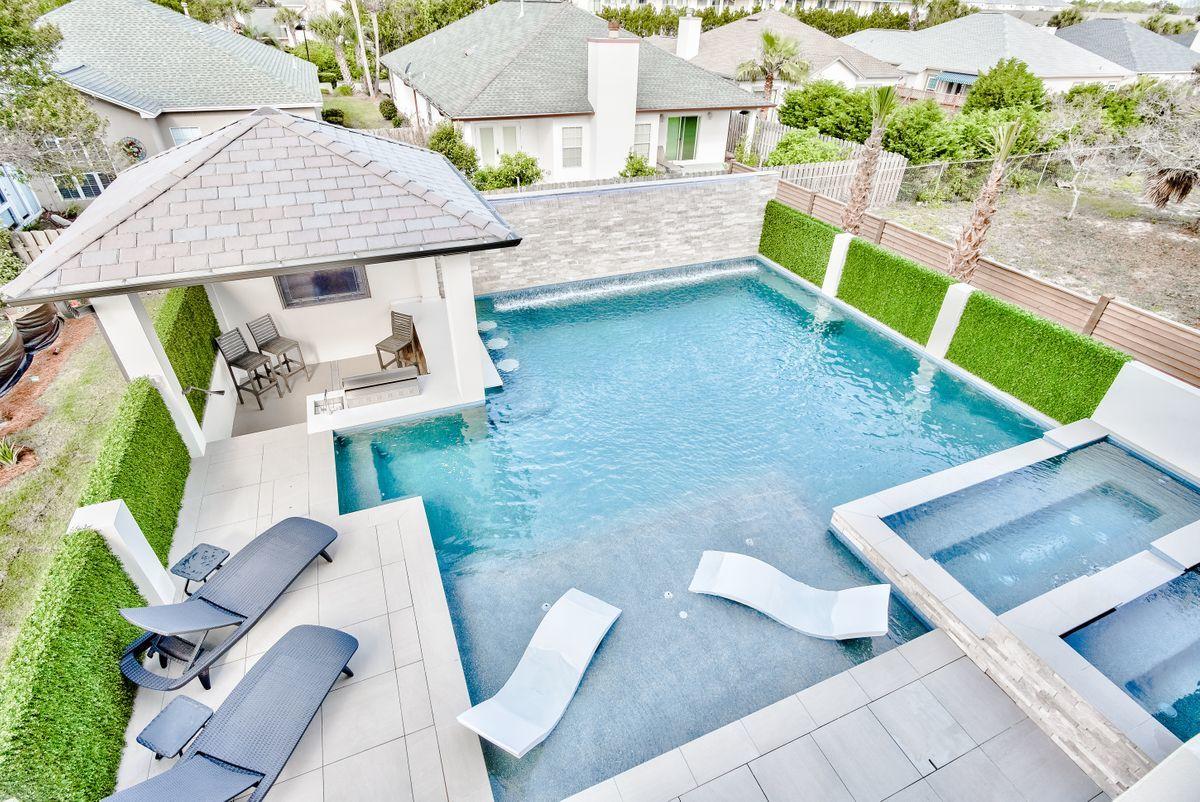 Pristine new construction paired with exceptional panoramic gulf views and resort style amenities beautifully characterize this extraordinary beachside retreat. 135 Ellis Road is prominently positioned just a few tiers back from the Gulf of Mexico boasting 10 bedrooms and 10 & 2 half bathrooms yielding masterful architectural details comprising 6,804 square feet. This ideal rental machine was thoughtfully designed to optimize sleeping capacity without compromising quality and function with over $300,000 in projected gross annual income. Notable features include a massive private pool & adjoining spa curated with ample space for soaking up the Florida sunshine while offering an array of outdoor entertaining space including a fully stocked summer kitchen as well as a pinterest-style swim up bar. The interior finishes are finely appointed with hurricane rated impact resistant windows and doors which offer exemplary natural lighting throughout the open floorplan. 

The first level is prime for entertaining inclusive of unparalleled amenities including a custom hibachi grilling area as well as adjoining living space adjacent to the resort style pool. The private elevator allows access to all four floors with a king bedroom located on the first level as well. There is a laundry room on both the first and third level for optimal convenience as well as a spacious single car garage with six additional parking spaces in the driveway. The second level anchors the home with an oversized living room and well-appointed kitchen offering a large center island and stainless appliances including a 48" Thermador gas range and refrigerator/freezer. In addition to the large kitchen, living and dining room, there are three large bedroom suites that each offer an ensuite bathroom. The third level is almost completely outfitted with bedroom suites yielding an impressive five full suites as well as a laundry access including an exceptional coastal bunk room with ample sleeping space for kids. The fourth level offers a full wet bar and adjoining open deck to soak in endless sunset vistas as well as gulf views. There is a top level bedroom suite and living space as well as a half bathroom and beverage center for mixing cocktails or enjoying a glass of wine. Other notable features include professional decor throughout, yielding a truly turn-key product.

This prime positioning is in the heart of Miramar Beach, Florida with walking distance to beach access as well as world class restaurants, coffee shops and local entertainment. Miramar Beach is positioned in the heart of South Walton County offering close proximity to excellent golf courses, grocery, boutique shopping and boating access.