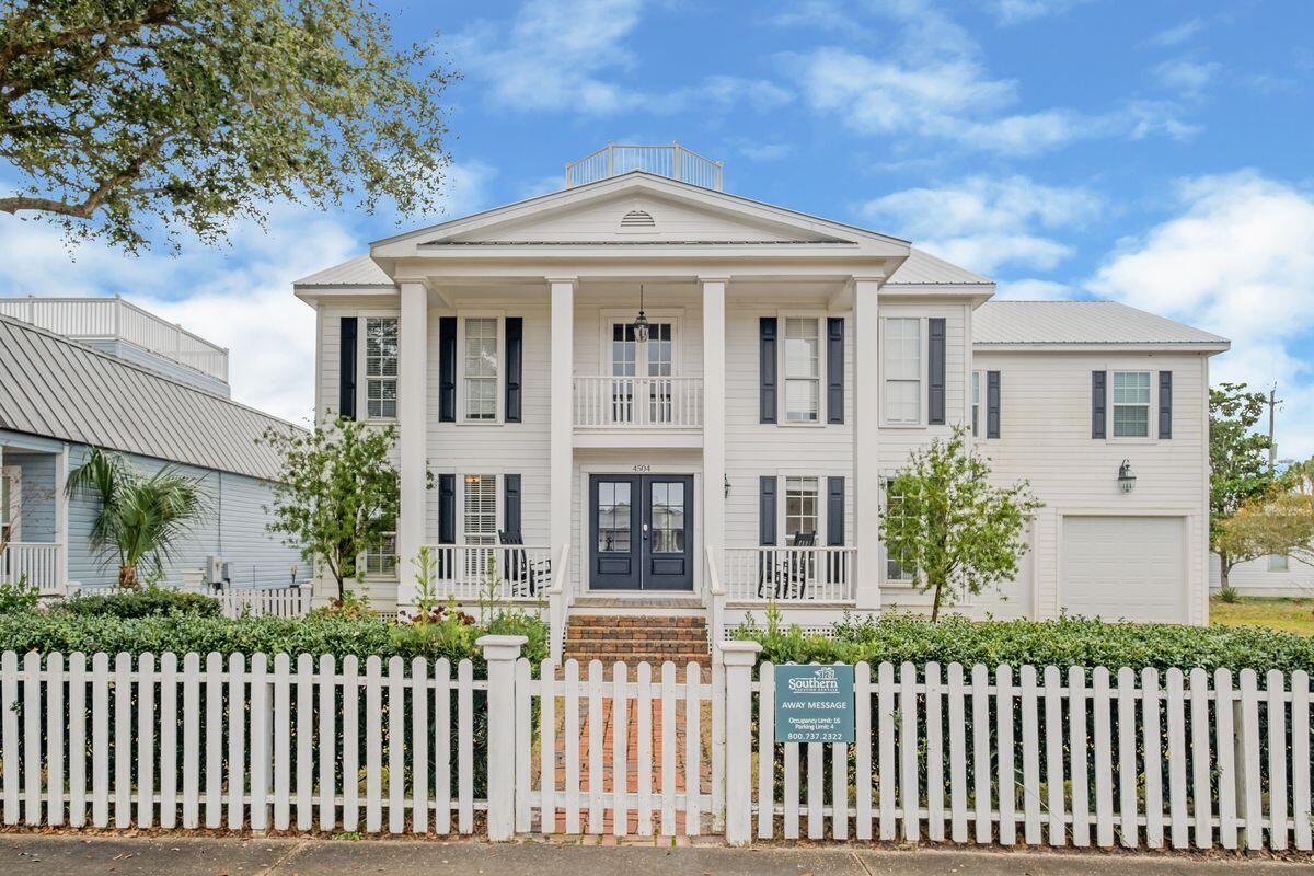 Located a short walk or golf cart ride from world-famous Crystal Beach, this is a home for those who like the luxury of extra space and a comfortable Florida lifestyle centered on the generous private pool. This spacious three-story home oozes character with an imposing plantation-style facade behind a white picket fence. To the side, a driveway leads to a two-car garage with ample storage for bikes and beach toys. Newly renovated, the interior of the home has noteworthy hardwood flooring, multiple living rooms and is tastefully furnished throughout. Note the main living room with exposed beams, adding a sense of character to the bright open space. The third floor provides flexible space as a home theater, playroom or office. Ideal for accommodating family and friends, three of the six bedrooms are extra-large suites. Cathedral ceilings grace the generous master suite which also has a balcony for quiet moments overlooking the saltwater pool and spillover spa. The chef-worthy kitchen has been updated with white cabinetry complimented by black quartz countertops, a gas range and full range of quality appliances. Outdoors, this attractive home continues to over-deliver. The good-sized yard has a large heated pool with lights that add an eye-catching glow after dark. Designed for entertaining, the pool bar/gazebo includes a double refrigerator and ample space for al fresco dining and relaxing. If you don't want to move right in and enjoy it yourself, this well-located beach house has an excellent track record as a luxury vacation rental, with projections of more than $200,000. With no HOA, and a cluster of restaurants, shopping and attractions nearby, this outstanding residence excels on all counts.