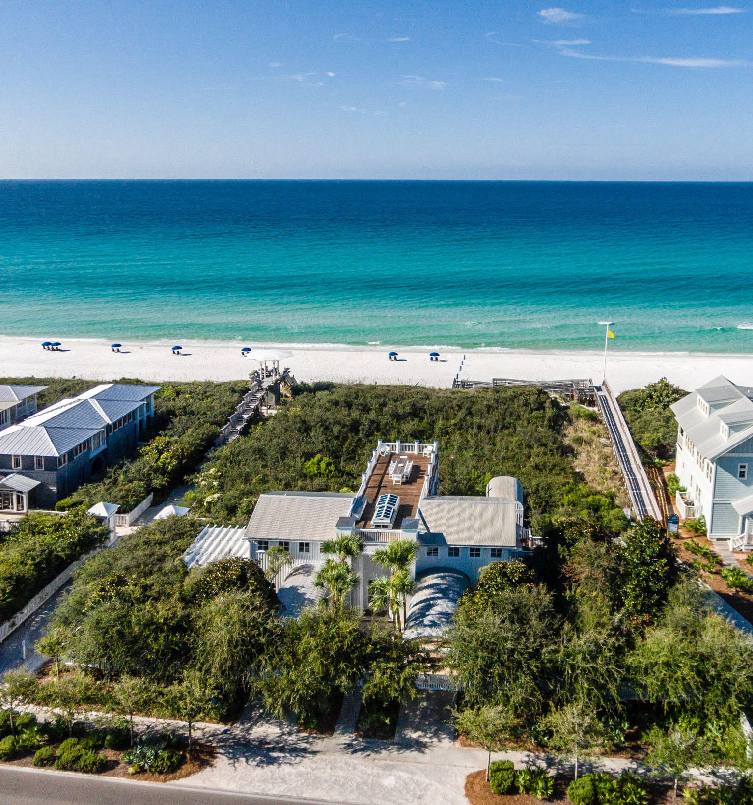 Three Gulfside lots, with a house by Pritzker Prize-winning architect, Aldo Rossi. Option to add two additional cottages, pool or private pavilion to create a large family compound on the vacant gulf front lots. This spectacular property is on Seaside's western edge, secluded but just a short stroll to downtown Seaside. The late Aldo Rossi was one of the greatest neo-rationalist architect of the late 20th century, and this is his only house in America. A pair of elegant order columns frames the entry to the house. An Oculus at the top of the entry porch gives a glimpse of the roof terrace. Rossi House was built with the best available materials, fixtures, appliances & tile work. Two guest bedrooms, each with private bath, laundry room and walk in storage closet on 1st floor. A beautifully crafted stair leads to the main floor at the upper level. The living room is a calm, serene space under a vaulted ceiling. Floor to ceiling windows on the south side over look the dunes and the sea. The kitchen is equipped with Bulthaup cabinets and Gaggenau and Miele appliances. The spacious dining room leads to a south-facing porch with views of the gulf. A motorized skylight retracts to allow access to the roof terrace, with panoramic views over the gulf and the town. The master bedroom, like the living room, is a calm, serene space. It has a vaulted ceiling and floor to ceiling windows overlooking the dunes and sea. The spacious master bath is lined with artfully-crafted stone, a steam shower with built in stone bench with thirteen shower heads. The Rossi house is classic elegance. Its beach pavilion was designed and built by Jersey Devil, America's most illustrious design-build architects and craftsmen.