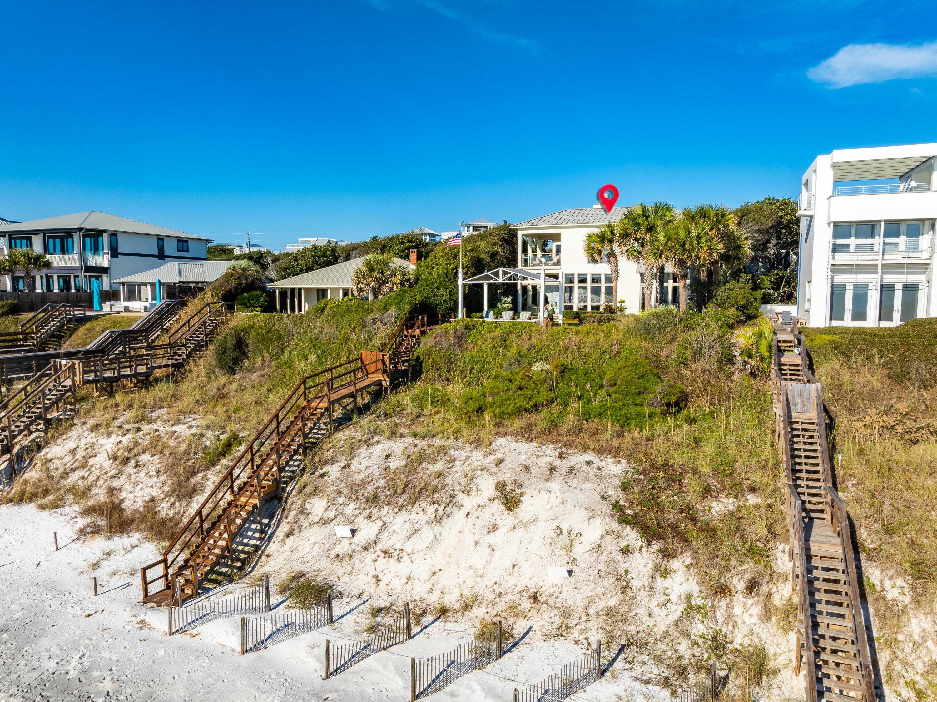 Sheltered beneath the iconic oak canopy of Old Seagrove, this architectural masterpiece captures the timeless beauty of 30A's Gulf Coast. Perched atop a 32-foot bluff with 60 feet of Gulf frontage, this 4-bedroom, 4.5-bath coastal estate spans 4031 square feet of exquisitely designed living space by Thurber Architects and recently reimagined by a renowned local designer. Every detail—new designer furnishings, custom window treatments, refreshed paint palette, upgraded A/V systems, lush new landscaping, and more—reflects a refined coastal aesthetic perfectly aligned with 30A's most exclusive lifestyle.
From the moment you arrive, every element speaks to sophisticated beachfront living: a private boardwalk to the sugar-white sands, heated Gulf-front pool,glass-walled loggia, and Gulf-front pavilion offering uninterrupted views of the turquoise the Gulf. Inside, a floating European white oak staircase illuminated by an Modern Chandelier introduces a stunning balance of artistry and architecture.
The main living area unfolds with floor-to-ceiling windows, a gas fireplace, and seamless indoor-outdoor connection to the loggia and pool. The chef's kitchen features professional-grade Wolf, Sub-Zero, Bosch, and Miele appliances, dual dishwashers, wine cooler, induction cooktop, and double ovenscrafted for both culinary mastery and entertaining. A first-floor master suite overlooks the Gulf, offering dual closets and a spa-inspired bath with radiant heated marble floors and a walk-in shower.
Upstairs, two guest suites each include private bathsone transformed into a bunk roomwhile the Gulf-front primary retreat offers a morning bar, second laundry, private balcony, custom closet, and spa bath with Italian marble and heated floors.
The residence is equipped with Lutron and Control4 home automation, 12-foot ceilings, custom drapery and electronic shades, and solid concrete construction secured by a sea wall.
Ideally situated just moments from Seaside and the heart of Scenic 30A, this Old Seagrove Gulf-front estate represents the pinnacle of modern coastal luxurya rare opportunity to own a fully updated, designer-furnished Gulf-front sanctuary where timeless craftsmanship meets effortless elegance.