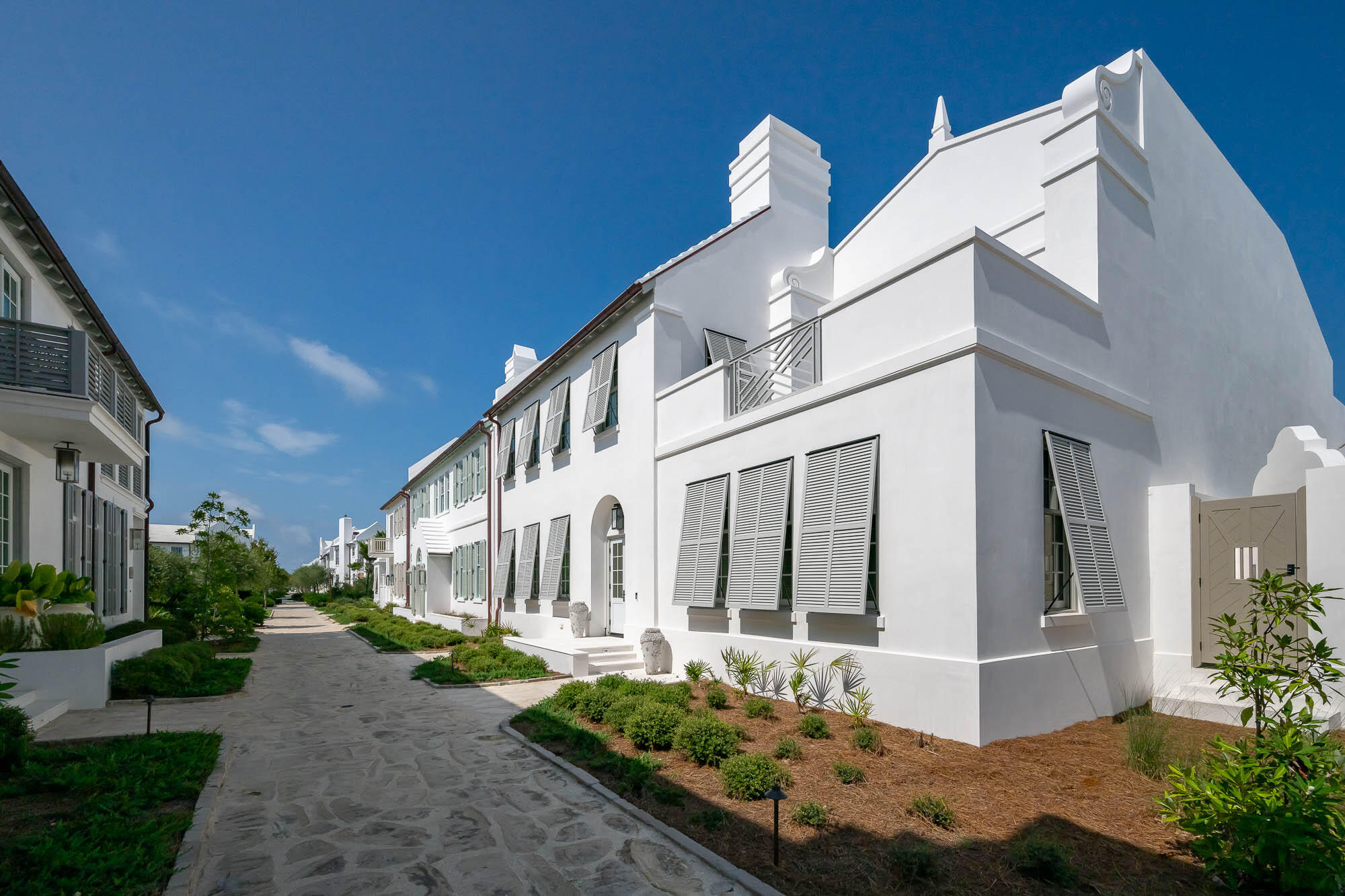 24 Smugglers Alley is a newly completed Alys Beach courtyard home built by Alys Beach Construction and designed by renowned Pledger Architect. This 4 bedroom plus bunk home fronts Turtle Bale Pedestrian Path which leads directly to the Turtle Bale Beach Access and Gulf of Mexico. The tasteful professionally designed interior furnishings set the tone upon entering the main foyer. An open layout floorplan offers a great flow into the living/dining/kitchen area with beautiful coffered ceilings and venetian plastered walls. The first floor also includes a large guest suite, laundry room, covered outdoor living area with summer kitchen, pool and lounge area. Two single car garages balance the alley entry of the home. On the second floor, the northern wing of the house is dedicated entirely to the primary bedroom suite which also has its own large private rooftop terrace. The southern wing is comprised of two guest suite bedrooms and a large bunk room.