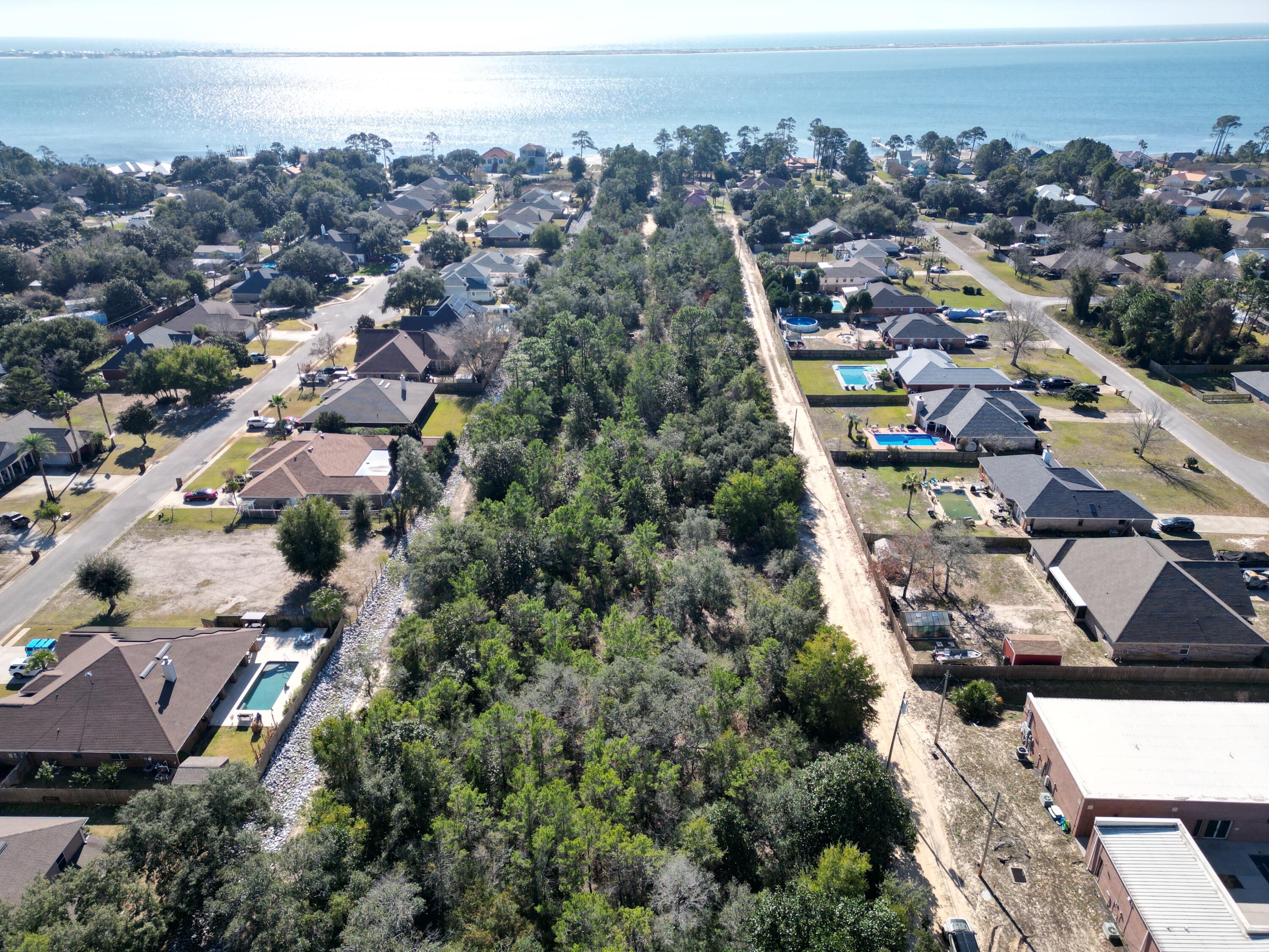 .505 Ac interior lot zoned R1 with Frontage 220. According to GIS map no wetlands are on property , x flood zone, see photos for other pertinent information . Additional .505 acre Lot MLS # 991909 on market for sale as well. Setbacks F25'  R25' S15' soil is Ortega Sand, 0-5% slopes not a Hydric soil. SEPTIC needed water at street and sewer on 98