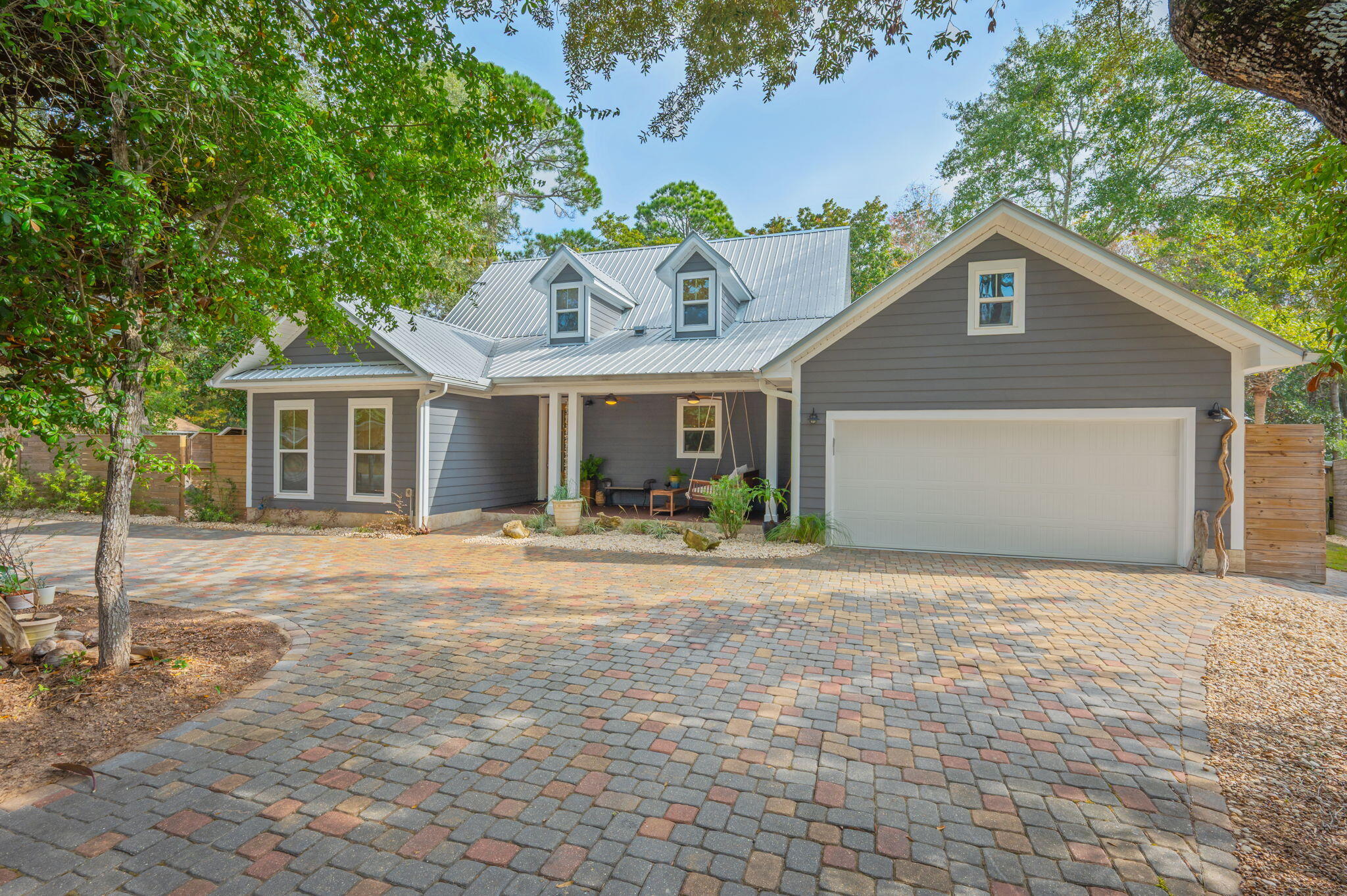 Discover the perfect blend of coastal elegance and robust, modern functionality in this stunning Niceville home. Every detail has been thoughtfully updated to create a luxurious and low-maintenance lifestyle, beginning with the interior's freshly painted walls and luxurious and durable luxury vinyl plank flooring throughout the entire home, contributing to a low-allergen living environment. The gourmet kitchen is a chef's dream with custom cabinets that extend to the ceiling and a large island. Comfort is assured with a Trane air conditioning system that is only 3 years old, and luxury touches abound, such as built-in speakers throughout the home and porches and a full surround sound system in the living room. The primary bath features a curb-less walk-in shower with a longitudinal drain. The large private balcony porch off the primary bedroom offers a serene retreat. A key feature for flexible living is the downstairs bedroom which has a separate entrance, making it ideal as an Airbnb rental, an au pair suite, or a private mother-in-law suite. The exterior's durability features a metal roof, hardboard siding, a Travertine wrapped foundation, and reinforced fencing. The property offers exceptional utility, including a full RV hookup surrounded by a privacy fence, a paver circle drive walkway, additional paver parking, and a separate golf cart garage. Outdoor living is maximized with a spacious large front porch featuring freshly stained concrete, an Alfresco dining deck with stained concrete and a sail shade, and a back patio/lanai area with a beautiful fire pit and wood shed. The backyard also features a dedicated hot tub deck with 50 amp power ready for you to install your dream hot tub. The yard is designed for low maintenance with newly sodded areas lined with fresh rock, and convenient access is provided by 6 ft gates to the backyard and an outdoor shower. Finally, the oversized garage has been transformed into a fantastic bonus room, featuring a custom epoxy garage floor and energy-efficient spray foam insulation in the large attic above.
The prime location seals the deal: you're just a quick walk or golf cart trip from the sparkling Bluewater Bay Marina. Imagine keeping your boat steps away and enjoying evenings at LJ Schooners, known for spectacular waterfront dining, stunning sunset views, and live music nights.