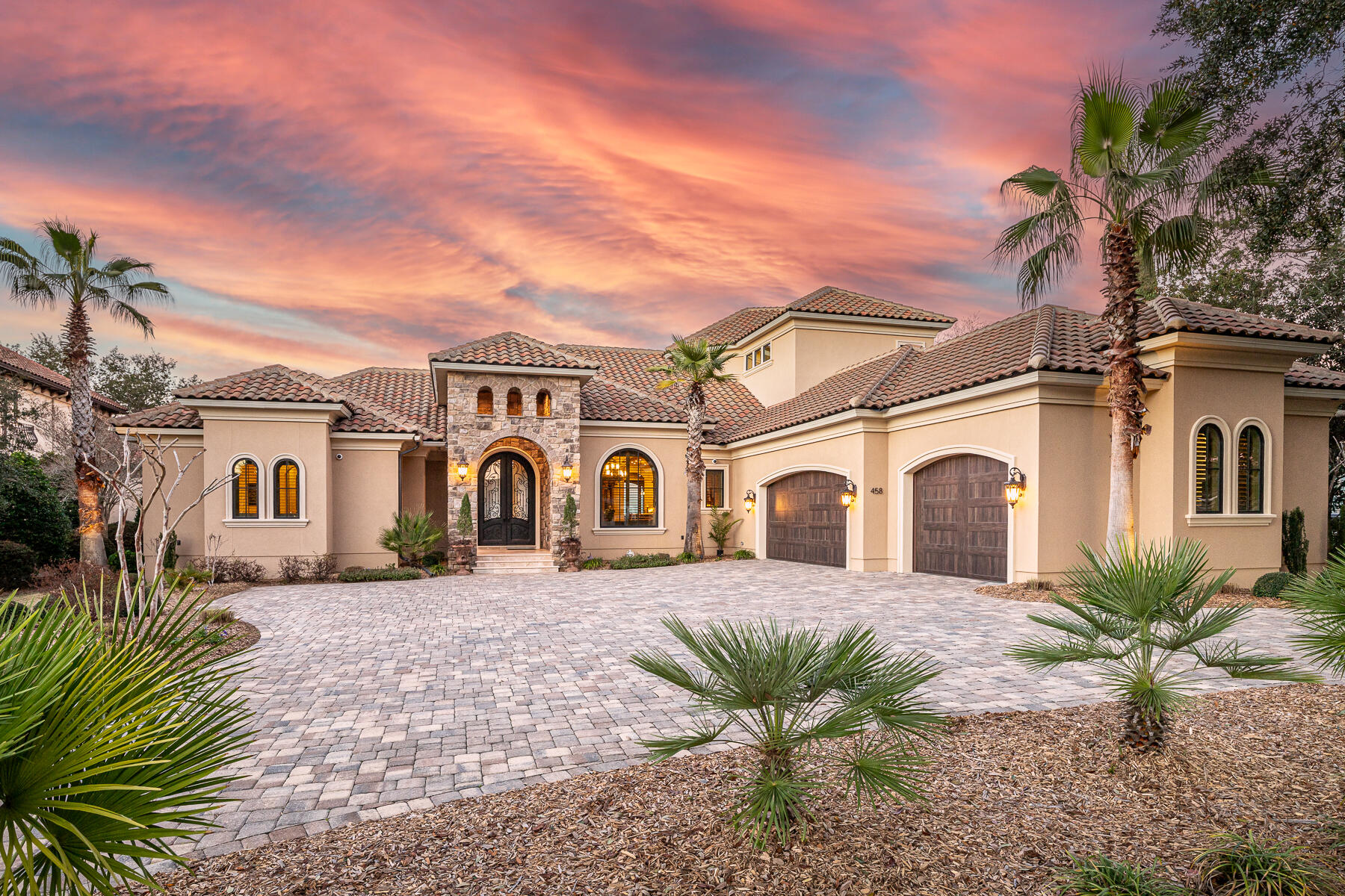 THIS EXQUISITE BAYFRONT PROPERTY IS A PREMIUM OPPORTUNITY FOR THE BUYER LOOKING FOR IMMACULATE PERFECTION. QUALITY BUILT BY DKM CUSTOM HOMES  THIS STUNNING MEDITERRANEAN MASTERPIECE BECKONS WITH 12 FOOT SOLID METAL HAND MADE FRONT DOORS WITH GLASS INLAYS FROM IMMENSE CIRCULAR PAVER DRIVEWAY. ONCE INSIDE THE SPACIOUS ENTRY WITH 16 FOOT SOARING CEILING YOU WILL BE AMAZED BY CUSTOM STAINED BEAM WORK AND CROWN MOLDING, STATELY COLUMNS, TRAVERTINE STONE FLOORING ALONG WITH HAND TROWELED AND GLAZED WALLS. DIRECTLY AHEAD IS THE LIVING AREA OPEN TO DINING ROOM AND CABANA BAR; ALL PERFECTLY INTEGRATED FOR ENTERTAINING GUESTS WHILE ENJOYING POOL AND BAY VIEWS. HEADING TO THE WEST WING FROM HERE IS A SEPARATE STUDY/OFFICE JUST OUTSIDE THE SUMPTUOUS MASTER SUITE WITH PROFESSIONALLY DESIGNED 18 X 12 FOOT WALK IN CLOSET, BATHROOM WITH SEPARATE GRANITE VANITIES, ROOMY CUSTOM CABINETRY, TRAVERTINE STONE, WHIRLPOOL TUB WITH EXTRA BACK JETS AND WALK IN SHOWER WITH BODY SPRAYS. SPACIOUS BEDROOM HAS ENGINEERED HARDWOOD FLOORS, TRAYED CEILINGS AND OFFERS GORGEOUS BAY VIEWS WITH LANAI ACCESS TO POOL AND SPA. THE EAST WING OF THE HOME FEATURES A CHEF'S KITCHEN WITH WOLF 5 BURNER COOKTOP, CONVECTION OVEN, MICROWAVE, STEAMER AND SUBZERO DOUBLE DOOR REFRIGERATOR/FREEZER, LARGE ISLAND WITH PREP SINK, WALK IN PANTRY,IMMENSE CUSTOM CABINETS, GRANITE COUNTERS, TILE BACKSPLASH AND CAST STONE VENT HOOD. THIS AREA SPILLS INTO EAT IN KITCHEN WITH POOL AND WATER VIEWS, AND GREAT ROOM WITH HEAT AND GLO FIREPLACE, CAST STONE SURROUND AND SLIDING GLASS DOORS LEADING TO LANAI WITH SALT WATER POOL, SPA, TANNING SHELF WITH FOUNTAINS, FULL SUMMER KITCHEN, SPACIOUS BACKYARD, TREX LINED DOCK, COVERED BOATHOUSE AND SEAWALL WITH SUBSTANTIAL RIP RAP. THE FIVE MILE AND PANORAMIC VIEWS INCLUSIVE OF THE MID BAY BRIDGE ARE INCREDIBLE FROM THIS LOCATION! BACK INDOORS ON THE FIRST FLOOR YOU WILL FIND A GUEST SUITE OFF FULL  LAUNDRY AREA AND STAIRS WITH SPECIALLY MADE METAL HANDRAILS THAT LEAD TO SECOND STORY RECREATION ROOM WITH 5 AND 1 STEREO SYSTEM, MINI KITCHEN, HALF BATH, BALCONY WITH STUNNING WATER VIEWS, 2 ADDITIONAL GUEST BEDROOMS WITH SHARED BATH AND SEPARATE WALK IN ATTIC  STORAGE WITH ICYNENE INSULATION. HOME ALSO FEATURES TANKLESS WATER HEATERS, CENTRAL VACUUM WITH BUILT IN RETRACTABLE HOSES, INTEGRATED AND STRUCTURE WIRING FOR SECURITY AND SURROUND AND CONTROL 4 TOUCH SCREEN PAD AND GENERAC 22 KW GENERATOR. OVERSIZED 3.5 CAR SIDE ENTRY GARAGE INCLUDES HARDCOAT EPOXY FINISHED FLOOR, BUILT IN CABINETS, ATTIC STORAGE AND HURRICANE RATED CUSTOM MADE EDEN COAST ALUMINUM GARAGE DOORS. AND FOR FURRY FRIENDS, THERE IS AN EXTERIOR FENCED DOG RUN WITH ARTIFICIAL GRASS ACCESSIBLE VIA DOGGY DOOR AND RAMP! REGATTA BAY AMENITIES INCLUDE GATED ENTRY, 18 HOLE GOLF COURSE, TENNIS, PICKLE BALL, COMMUNITY POOL, PLAYGROUND, GRAND CLUBHOUSE AND LOCATION IS CONVENIENT TO A FULL SERVICE MARINA, GORGEOUS GULF BEACHES, PREMIUM SHOPPING AND DINING ALONG THE EMERALD COAST.