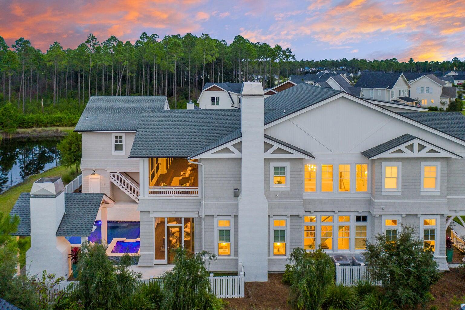 As you approach this stunning estate, the grand entryway gives you a glimpse of what awaits beyond the welcoming mahogany doors. This opulent home also features a one-bedroom carriage house which is perfect for multigenerational living or a private guest space. Encompassing five bedrooms, five bathrooms and two half baths totaling 4625 square feet.

Every detail of this expansive Chris Stoyles, Turner Legacy custom home has been thoughtfully curated. From the imported Marquis cabinetry, kallista sinks, euro doors, automated window treatments, $100,000 in upgraded elevated AV system with sound wired inside and out, cell boost in every room, GENERAC generator, separate cabana with outdoor fireplace and pecky cypress mantle, infared heaters, media center, heated infinity edge pool, and spa The home features an elevated AV control four system, three fireplaces, two laundry suites, custom mahogany doors and barn doors, two wet bars, custom maple stairs, Sub Zero, Wolf, Fisher & Paykel appliances, Kohler fixtures, and custom furnishings curated by Nest Interiors, NYC.

There are a myriad of and entertaining spaces in this home including a well designed second-floor screened porch with swing bench overlooking the serene pond with forest views. Additional attic space could be converted into an additional media room, gym, or private office above the second floor.

Experience an elevated lifestyle while dining al fresco with control four at your fingertips to curate your favorite audio artist. Take a dip in the infinity edge pool after dinner and sip your favorite cocktail to the sounds of your waterfall with a waterfront expanse.

The community of WaterSound Origins offers various amenities including a fitness center, golf course and community pool. The location, beauty and precision of this home is a rare find and makes it a must see for anyone looking for a picturesque Florida escape with unparalleled amenities. Access to community amenities also include a par three golf course, tennis and pickle ball courts, nature trails, resort pool, dock access, and community gatherings.

Membership to the exclusive Watersound Club membership offering pristine pools and private Beach Club, multiple award-winning golf courses, tennis courts, pickle ball, spa, hotel, and shooting range.