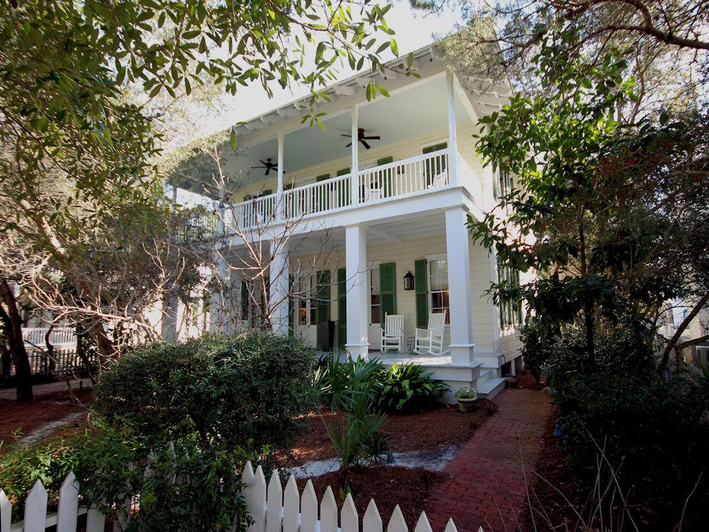 Located on Seaside's grand boulevard lined with an array of stately plantation style homes. The original home and guest quarters designed by Richard Gibbs for his personal residence while he was Seaside's town architect. The house was later expanded to accommodate the current family. The original design by Richard was preserved during the design phase. The front porches span the width of the home and expand the living and dining areas to the outdoors by three sets of French doors. A brick fireplace opens from living through to kitchen for all to enjoy. Kitchen was updated with custom made cabinets, marble countertops, Viking and Subzero appliances, 4 burner gas stove and expanded with a spacious butler's pantry. Laundry and half bath tucked behind kitchen. Con't Master suite with his and hers separate baths also on first level. Second level includes three guest bedrooms, private baths with marble, subway and glass tiles.  Media room with half bath and office/play room also on second level. Ascend to the finished attic that has been converted to children's sleeping loft. A reading room at the third level leads to the covered tower with panoramic views of the town, Gulf of Mexico, and extraordinary sunsets. Rounding out this masterpiece is the separate one bedroom, one bath guest quarters with private porch, comfy living area and kitchen above the garage. Beautiful grounds, mature trees, courtyard, garden with water feature and paved driveway with private parking. Excellent location to all Seaside amenities. The pristine condition of this home sets it apart from all others. Square footage, bed and bath count includes guest quarters.