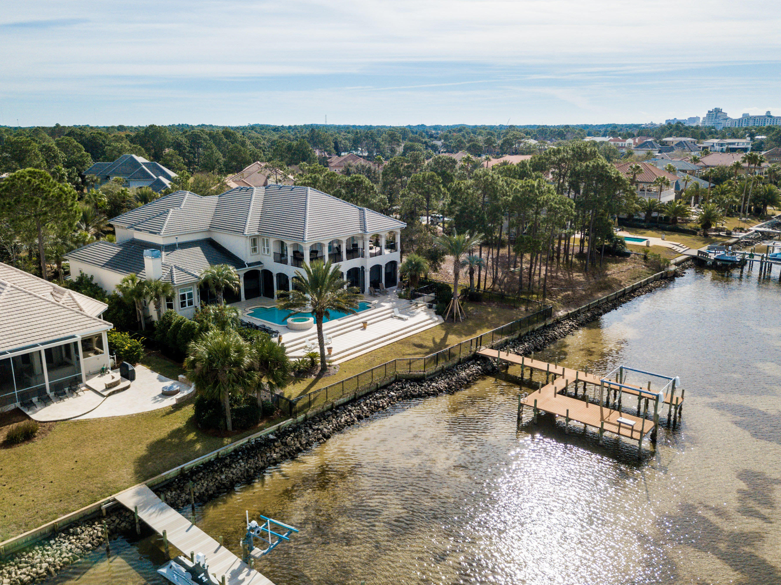 Amazing Bay Front Estate Home located within the double gated community of Burnt Pine at the Sandestin Golf and Beach Resort. Unobstructed views of the Choctawhatchee Bay from almost every room of this beautiful, one of a kind, custom built residence. Never before offered for purchase, you will not be disappointed with the infinite list of high end finishes throughout. Enjoy the beautiful sunrise every morning from the main level Master Suite which features double trey ceilings, fireplace, sitting area, french door access to screened lanai, and separate his and her closets. Spacious Master Bath with every feature you would expect including a round jetted tub. Chef's Kitchen includes Viking Professional Grade appliances, separate wet bar, and casual dining space with unobstructed views of the water.  Formal living area just off the foyer with access to the Study which boasts library style built in book cases.  Also on the main level, there is ample room for relaxing in the casual great room, and plenty of room for entertaining in the formal living room which also features a temperature controlled wine cellar fit for the most avid wine enthusiast.  Easy accommodations for your guests on the main level with a additional bedroom and en suite full bath.  The beautiful winding staircase takes you to the second floor where you will find 3 additional over sized bedrooms each with en suite full baths, a spacious living area with mini-kitchen, and a work out room with french door access to the upstairs balcony which also overlooks the bay.  The creative design of the outdoor living space makes the most of this very private serene setting.  The fully equipped Summer Kitchen, Screened Lanai, Swimming Pool, Separate Hot Tub, Fenced Backyard, and Boat Dock Access to the Bay make it possible to enjoy this truly unique location year around.  Rannai endless hot water, central vacuum, climate controlled storage, bonus room storage, laundry room with separate pet shower, and an elevator are just a few of the features that the most discriminating buyer will appreciate.  You will not want to miss out on this extremely rare opportunity to own an estate home situated on the water in this prestigious neighborhood.