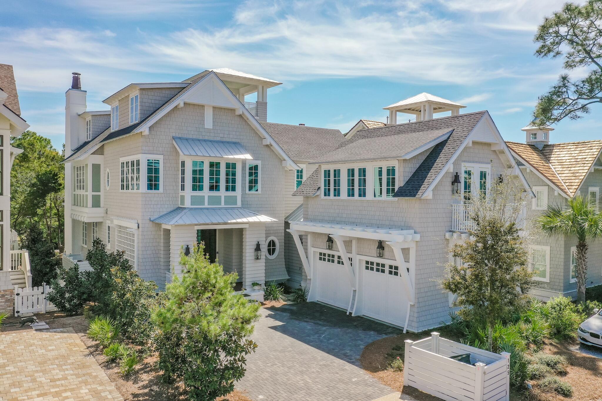 Located behind the private gates of WaterSound Beach, this coastal retreat boasts over 4,800 square feet of thoughtfully designed living space executed by the sought after architect T.S. Adams and the renowned building team at Dune Construction. A true icon of craftsmanship, the highest level of finishes and articulated positioning taking full advantage of the covetable Gulf views can be appreciated throughout. 

Upon entering the front door you are greeted by the foyer with charming ship lap lined walls and stunning wood flooring. Flowing seamlessly into the living area, the Chef's kitchen features custom cabinetry, an oversized island with an integrated breakfast bar, and a luxury appliance suite.