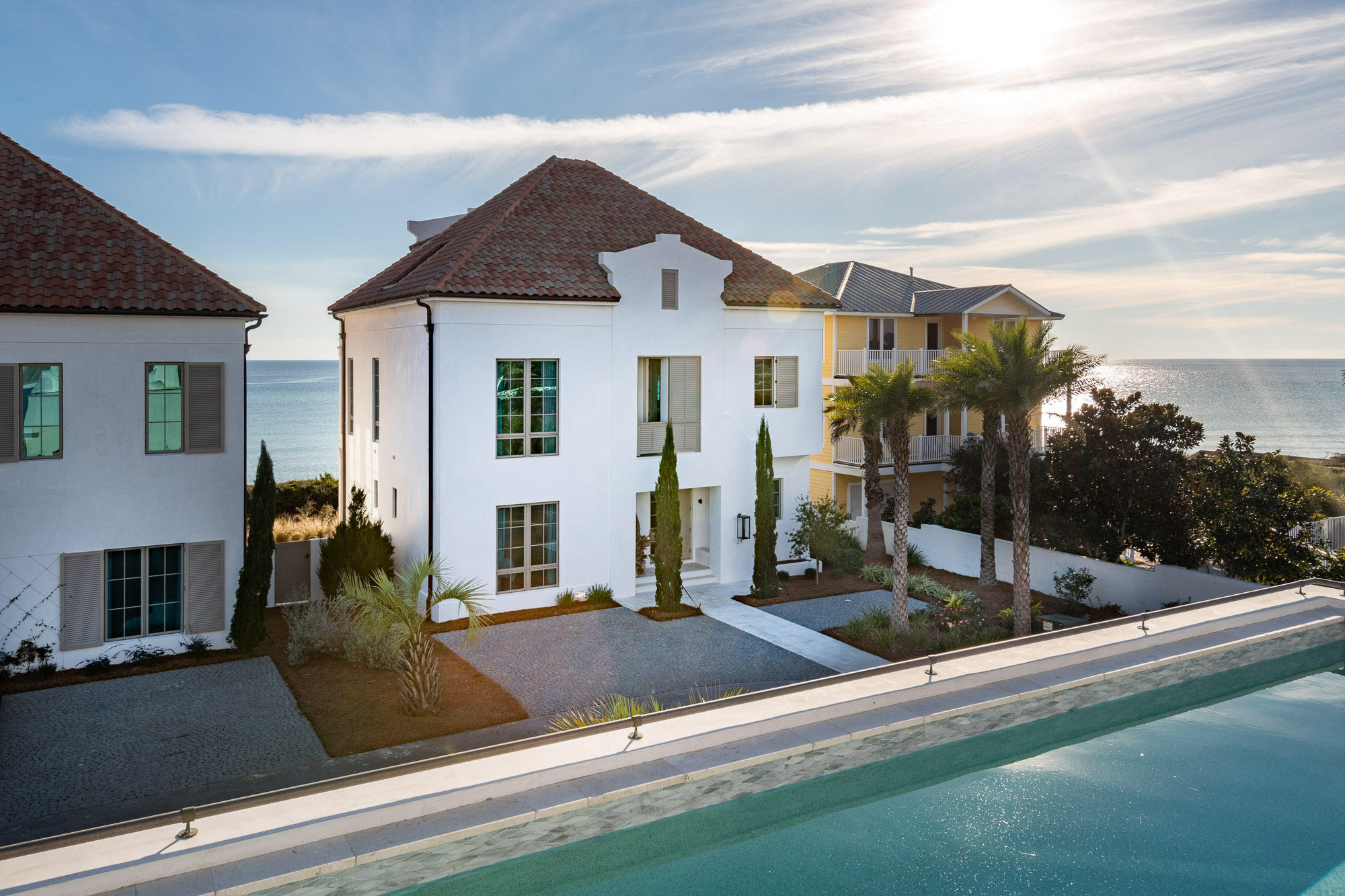 Discover the luxury of quiet Gulf-front living at 24 Escape Drive. Offered fully furnished with high-end interiors, this custom beach residence is ideally poised in a small gated community, a prime location just a stroll east of Rosemary Beach (2,000 feet). Designed by renowned architectural firm, A BOHEME Design, the concrete residence is built to meet FORTIFIED For Safer Living standards. A private community walkover lends convenient beach access and the community shares an impressive rooftop pool and entertainment cabana. An ideal and spacious floor plan boasts an open living concept with the main living areas, kitchen and dining all open and facing the Gulf, lending expansive Gulf views. Stone flooring throughout the first level and all bathrooms and wire-brushed hardwood is appointed to the upper levels.  A secondary  master suite, with a charming private Gulf-front porch, and two additional guest suites are located on the lower level of the home.  The fully appointed kitchen includes an additional wet bar and a butler's pantry.  The third level exclusively houses the private master suite, facing the Gulf and presenting breathtaking views!  Open your eyes in the morning to the rolling waves and peaceful beach vista.   A detached garage lends ideal enclosed parking, with additional exterior parking spaces at the entrance to the home.  An exterior access storage closet provides ample storage for outdoor beach gear and bicycles. Your ownership includes a 1/4th interest in the homesite (lot 1) that is the location of the rooftop pool, community cabana and entertainment pool deck and one private parking garage. This common ground is owned by the Escape Homeowner's Association,  a common area for the homeowners to enjoy.  Discover this exquisite Gulf-front community, at 30A's popular and coveted east end.