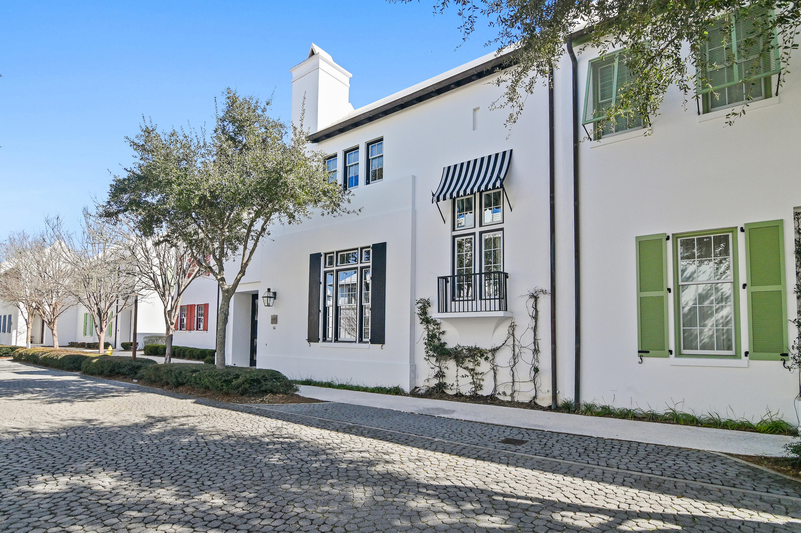 Ideally positioned in one of the most sought-after areas of Alys Beach, this custom coastal home offers timeless architecture paired with a warm, welcoming feel. Set along one of the community's older, tree-lined streets, the home enjoys a charming setting just a short walk to Raw & Juicy, the neighborhood playground, town center, caliza pool and the private beach club. Inside, the striking 13 ft dining room ceiling creates an immediate sense of volume and light. The open living space is generous and comfortable, centered around a fireplace and designed to easily gather family and friends. Tall doors open to two private courtyards that flank the home, allowing indoor and outdoor living to flow together in a way that feels effortless and distinctly Alys Beach. Two guest suites are positioned on the main level, each with its own en-suite bath and a private sitting area, providing comfort and separation for family or visitors. Interior finishes include coral stone countertops, slate flooring, and Venetian plaster, reflecting the classic material palette associated with Alys Beach.
The second level is dedicated to a private primary suite with a sitting area and French doors opening to a quiet balcony overlooking the courtyard below to hear the fountain. Designed for both everyday living and hosting, the residence captures the essence of Alys Beach's signature courtyard lifestyle along the Emerald Coast.