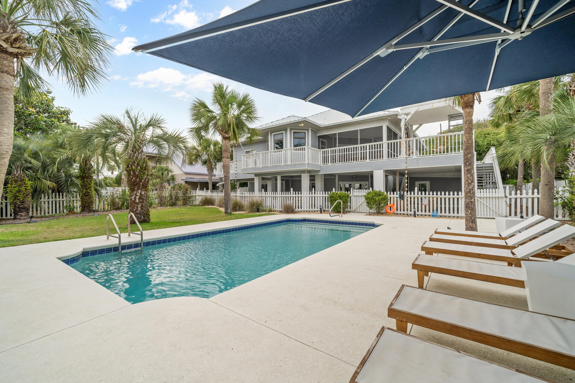 Seller will consider contributing up to $50K toward Buyer closing costs/rate buy down with an accepted contract! Up to $275K in rental projections! Step into coastal luxury with this beautifully remodeled and fully furnished Serena and Lily-inspired beach house tucked away on a rare nearly half acre of tropical lush landscape just steps from the sugar white sands of Inlet Beach just outside of Rosemary Beach. Surrounded by mature palm trees, this tropical retreat features an expansive 32-foot pool, multiple sun-soaked decks, and private deeded beach access that leads you steps away to the Gulf of Mexico. Designed for flexibility and comfort, the home offers two separate private lock-out units, each complete with its own kitchen, laundry, and living quarters—ideal for large families (sleeps 16+), vacation rentals, hosting with ease. Enjoy a resort style backyard with firepit and stunning pool and sunset views from the expansive decks with the Gulf as your backdrop. Turnkey and income ready with strong rental projections, the home comes fully furnished with a 6 seater golf cart, 6 bikes, a 2 car garage and ample parking, ideally located near Rosemary Beach and 30A Avenue for easy access to premier dining, shopping and entertainment- this property delivers the ultimate beach lifestyle and a smart investment in the Scenic 30A area.