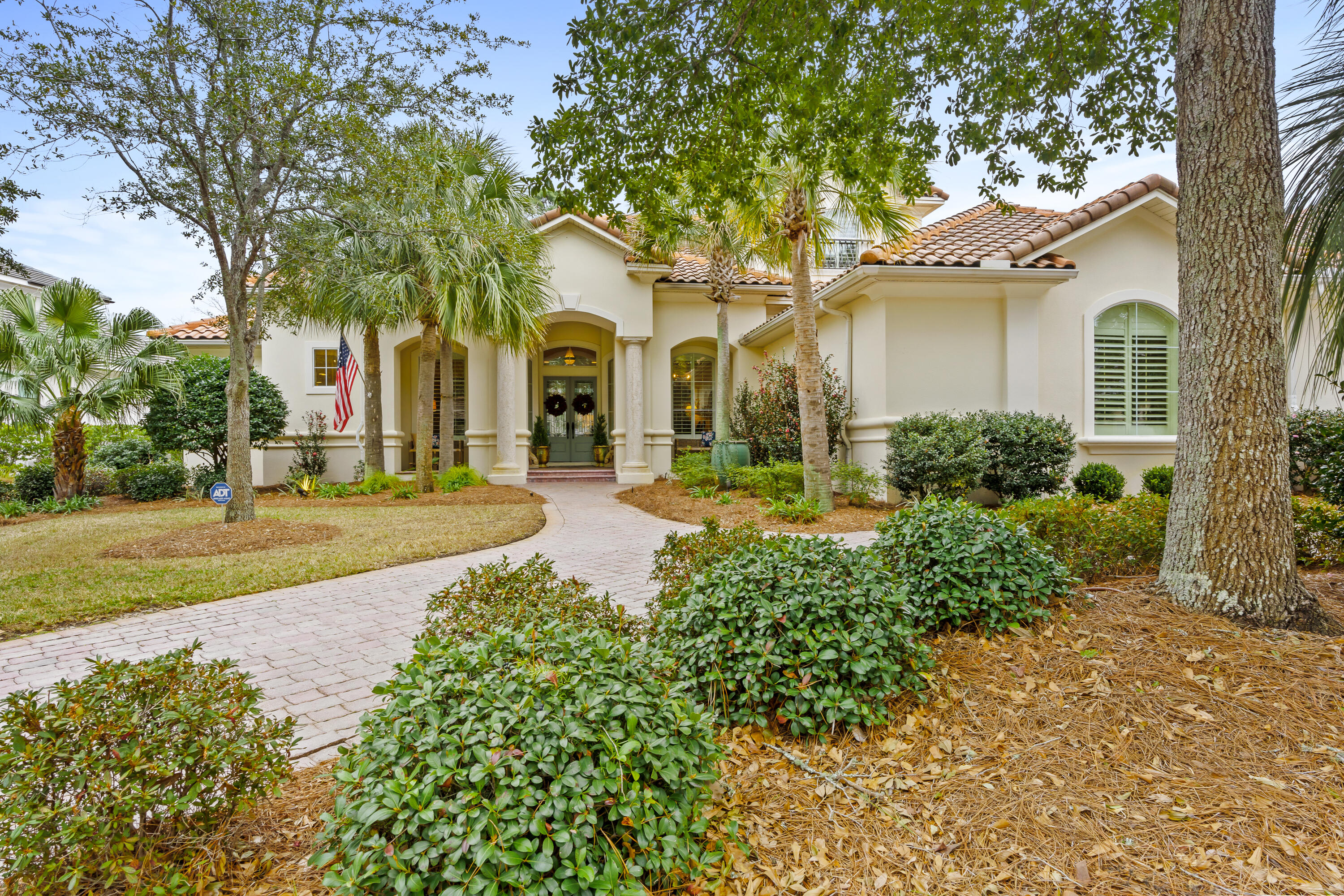 This lovely lake-view residence is located within the gated neighborhood of Burnt Pine and is perfectly nestled along the 12th hole of the Burnt Pine Golf Course.  It's all about location and quality, and this custom-built beauty by Sweet Homebuilders checks all the boxes.  An extremely well-designed floor plan with 4 bedrooms and 4 full baths, a stunning offering that is sure to please.  The master suite is situated just off the spacious living area, and it is also opposite the guest rooms on the main level so that owners and their guests maintain privacy.  With an oversized walk-in shower, separate his and her closets, accent lighting, elaborate niches, and serene views, the owners will treasure their time spent in the peaceful master retreat.  The main level is anchored by the inviting living area, providing a comfortable gathering space.  Impressive and functional kitchen with double ovens, two dishwashers, a separate ice machine, an array of top of the line appliances, beautiful cabinetry, a spacious pantry, wet bar, and easy access to both the breakfast nook and the formal dining room.  Entertaining is a breeze as the summer kitchen, complete with built in outdoor grill and refrigerator, is conveniently located just steps from the main kitchen.  The outdoor living area is reminiscent of a tropical paradise, as the fully screened lanai is flanked with lush landscaping.  The lanai includes a generously proportioned heated pool, making this outdoor space enjoyable year around.  On the main level are two additional guest suites, each with a private bath. One of the guest suites can also be locked off so that it has a separate entrance, a truly unique feature promoting flexibility and privacy. Extended family and guests alike are certain to enjoy the upstairs area which boasts beautiful views of the lake and the golf course from the balcony, a secondary master suite with full bath, as well as a separate living area.  Other notable features include two full car garage spaces with a separate golf cart garage, planation shutters throughout the home, fenced backyard, alarm system, new state of the art generator, two new zoned HVAC units, new electrical wiring with timers for lighting, and an abundance of storage space in the upstairs floored attic.