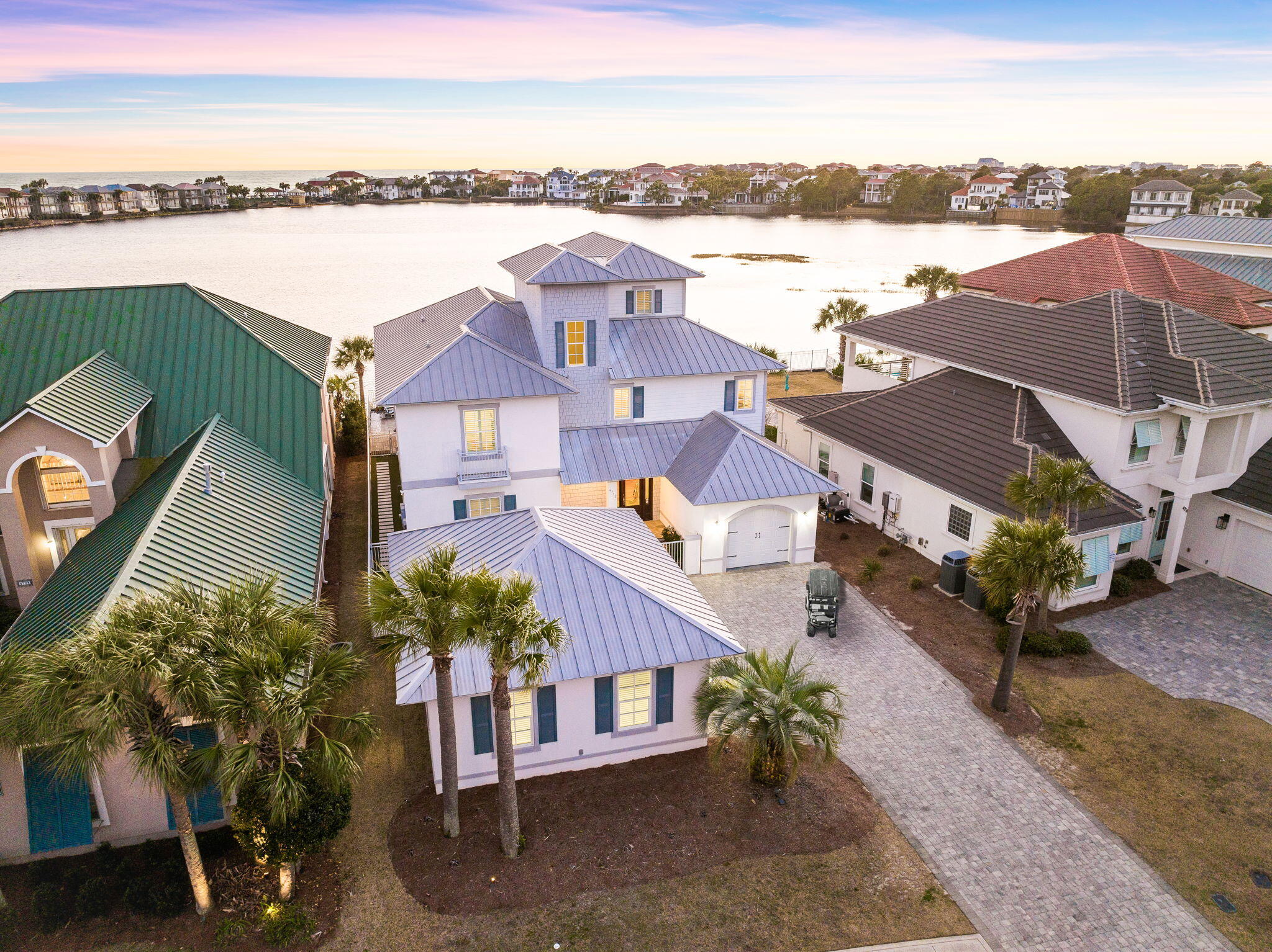 Seller financing available. INVESTORS ALERT! This stunning property generated over $260,000 in gross rental income in 2023, making it a prime investment opportunity. Located on one of the most sought-after lots in Destiny East, this home offers unparalleled panoramic views of both the lake and the Gulf, arguably the best in Destin! Whether you're in the market for a primary residence, vacation getaway, or a high-performing rental property, 'Sundancer' has it all.

Step inside to find charm and elegance at every turn, with custom finishes throughout. The open-concept kitchen flows seamlessly into expansive living areas, perfect for entertaining. With six spacious bedrooms, including a dedicated bunk room, there's plenty of space for family and guests to relax in comfort.