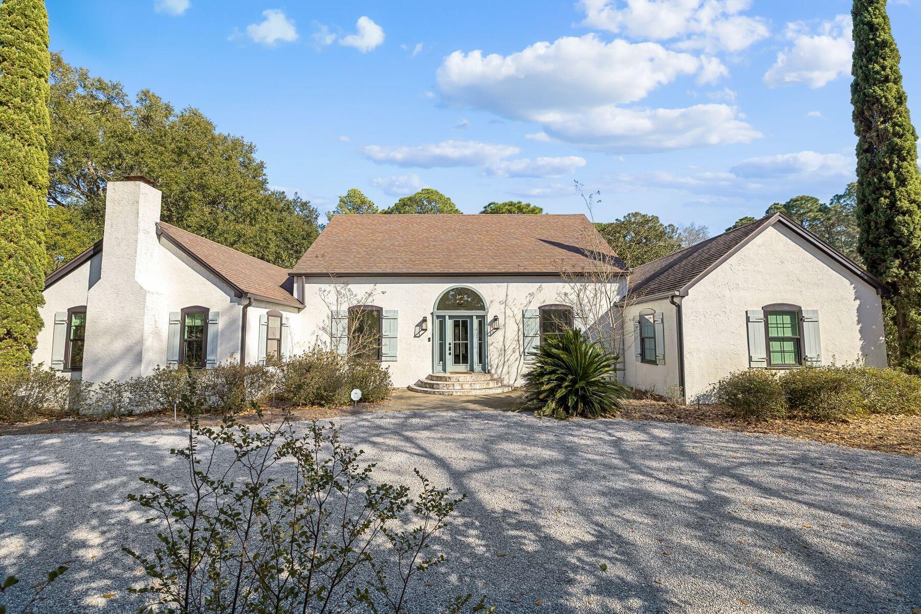 An extraordinary waterfront sanctuary awaits at this fully renovated canal-front residence, privately positioned on an estate-sized one-acre homesite in the heart of Santa Rosa Beach. Offering increasingly rare acreage just minutes from Scenic 30A, this property delivers a compelling blend of space, privacy, and waterfront access. Framed by magnolias, grand live oaks, and lush indigenous landscaping, the setting feels serene while remaining close to the sugar-white beaches, dining, and lifestyle amenities that define the area. A private canal dock provides direct water access with a 10,000 pound boat lift.

The 3,070-square-foot interior was meticulously renovated in 2022, blending timeless character with modern refinement. New impact windows, HVAC, and roof were just a few items updated. An expansive 600-square-foot enclosed lanai spans the width of the home, thoughtfully oriented to capture peaceful backyard views and extend living spaces year-round.

The expansive grounds provide exceptional flexibility, with ample room for a future pool, guest house, carriage house, or additional garage--offering the opportunity to create a true estate compound tailored to your vision. A heated and cooled flex space (not included in the square footage) located behind the garage adds further versatility, ideal as a private office, fitness studio, creative retreat, workshop, or conditioned storage.

Remarkable privacy and natural beauty are paired with unmatched convenience, just moments from Grand Boulevard's boutique shopping and dining, Sacred Heart Medical Center, and the best of Scenic 30A.

A truly exceptional offering--combining estate-sized acreage, waterfront access, and modern renovation in one of Santa Rosa Beach's most desirable settings.
New Roof Installed in 2014.
