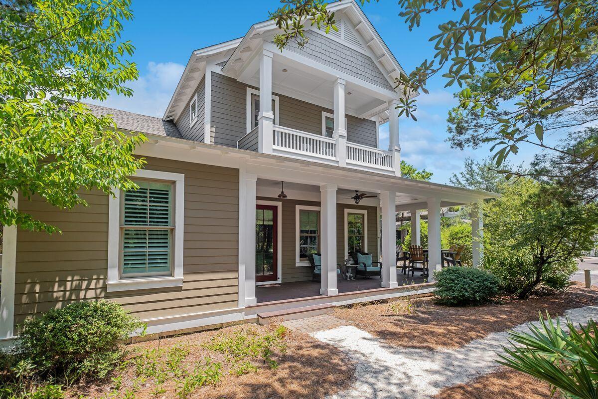 Buffered by mature trees, this beautiful Nantucket-style residence is in a quieter part of WaterSound near a private gate to the beach. Ideal as a primary residence or vacation home, this charming home was crafted by Arthur Rutenberg and is crammed with modern upgrades and amenities. Sitting on a generous corner lot with a 10-foot easement, it offers an exceptional outdoor lifestyle with more than 600 square feet of porches. On the main level, the living area is the hub of the home with a well-equipped open kitchen to delight keen cooks. As well as a full range of cabinets, it has quality Bosch appliances and a breakfast bar for socializing over pre-dinner cocktails and appetizers. A large island provides additional prep space and there's a spacious dining area for laid-back entertaining. The sitting room is a bright space for relaxing with windows casting daylight across the gleaming hardwood flooring. Throw open the French doors and enjoy fresh air and views of Puttering Park from the wrap-around deck. Also on the first floor, there's a light-filled master suite allowing owners to live on one level and keep the second floor for visiting guests. The master bathroom is a spa-like retreat with a jacuzzi tub, a separate shower and his-and-hers vanities. It leads into a massive dressing room/walk-in closet. Upstairs, the quirky loft space houses two additional bedrooms with ensuite baths and high ceilings. A second sitting area/media room separates the two main bedrooms and an additional bunk room caters to young guests. A short hallway leads to the balcony for enjoying morning views of the park and surrounding neighborhood. Additional benefits of this well-planned home include a whole-house gas generator, impact-resistant windows, tankless hot water system and a garage large enough to house a vehicle and a golf cart. There's ample parking for three more cars on the expansive pavered driveway. This luxurious beach home has all the advantages of the exclusive WaterSound community including gated security and deeded beach access. Head over the sand dunes and enjoy tranquil morning walks with the seabirds or romantic sunset strolls collecting shells. There's a fitness center, community pool, parks and seven miles of boardwalks and trails encouraging a healthy active lifestyle in this slice of Florida paradise.