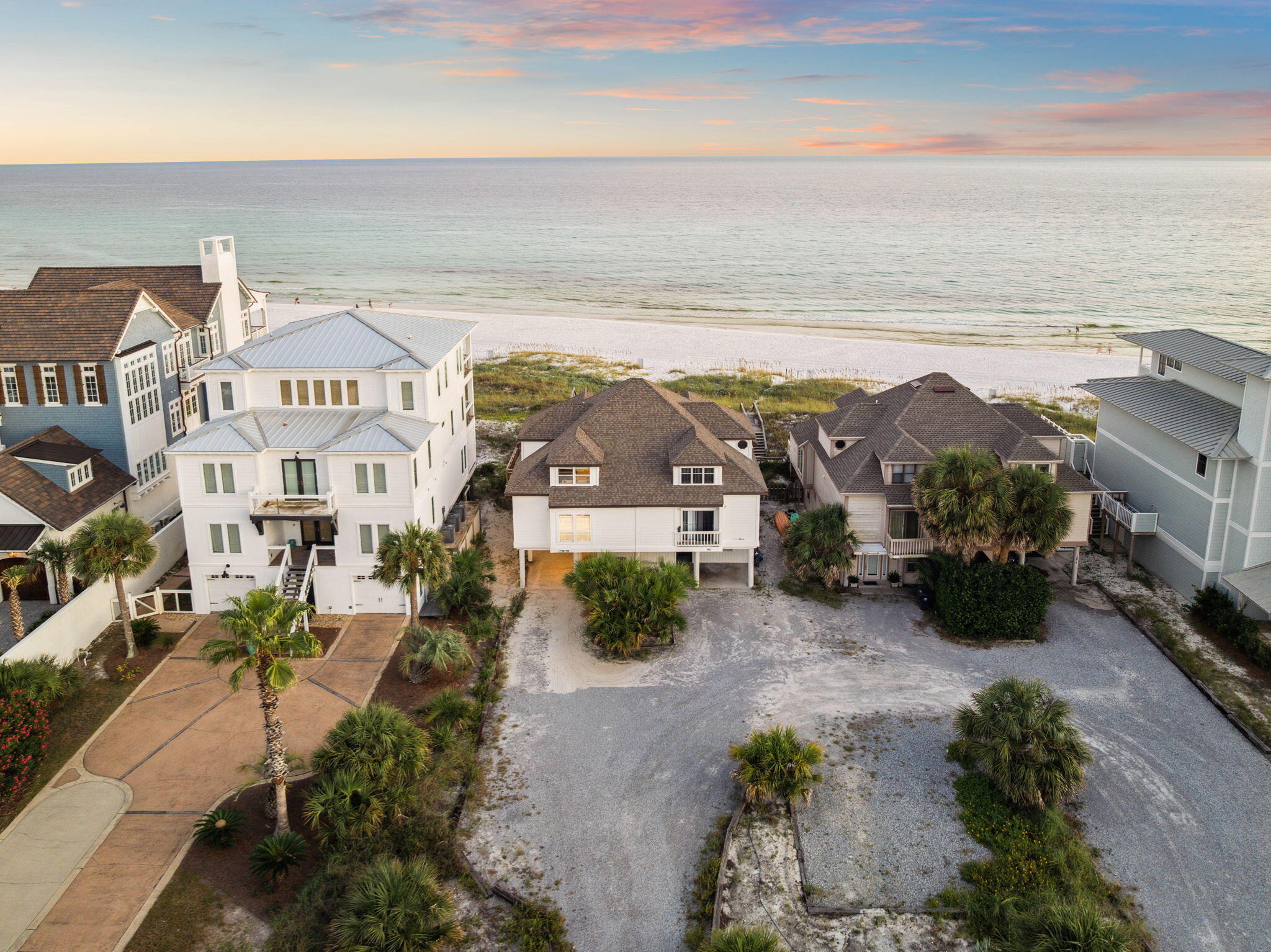 Rare Gulf front opportunity on pristine beachfront with private beach access. This oversized homesite is perfectly positioned on San Roy Road, a quiet dead-end street offering the unique advantage of being situated between the emerald waters of the Gulf of Mexico and the tranquil Eastern Lake.

The property includes a charming 3-bedroom, 2-bathroom townhome with 2,145 square feet of comfortable living space. The open concept design seamlessly connects the kitchen, dining, and living areas, all enhanced by beautiful Gulf views. Step outside to the covered Gulf-facing patio where you can enjoy morning coffee with sunrise views or evening gatherings with spectacular sunsets as your backdrop. Conveniently located on the south side of 30A in the heart of Seagrove Beach, you'll find yourself perfectly positioned between some of the coast's most sought-after destinations. Seaside's charming shops and restaurants are just minutes to the west, while the luxury of Alys Beach and Rosemary Beach await to the east, putting world-class dining, boutique shopping, and coastal entertainment at your fingertips.

The generous lot size presents exciting possibilities for those dreaming of a custom coastal estate. Current county regulations allow one parking space per 900 square feet, providing ample opportunity for a substantial home. Recent construction in the area showcases the potential for luxury residences exceeding 9,000 square feet, demonstrating the remarkable development possibilities this site offers.

What truly sets this property apart is its extraordinary dual water access between the Gulf and Eastern Lake, creating endless recreational opportunities right at your doorstep. The private dead-end street ensures peaceful surroundings while the exclusive beach frontage means no crowded public access points to navigate.

Whether you envision this as your coastal retreat, a vacation getaway, or a sound investment opportunity, the existing townhome provides immediate enjoyment while you plan your next chapter. This rare combination of location, privacy, and development potential makes 95 San Roy Road a truly special offering in one of Florida's most desirable coastal communities.