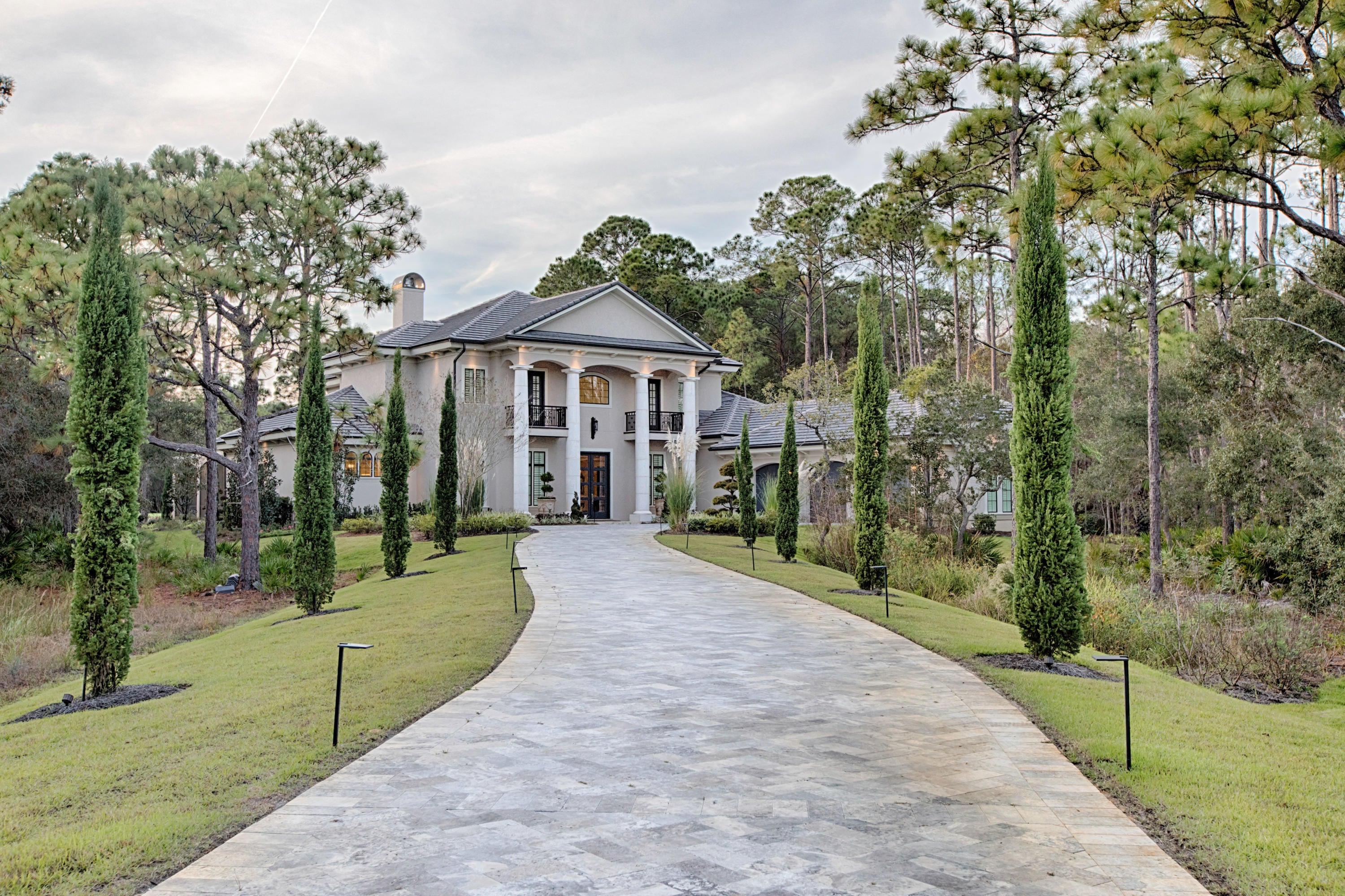 This majestic home located on the 4th hole of the Burnt Pine golf course captures the essence of elegance with the grandest celebration of luxury.  Modern double front doors accented by four stately columns welcome you into a massive open living area illuminated by opulent chandeliers and enhanced by a winding wrought iron banister staircase .  Dark wood beamed ceilings contrast impeccably with cream walls and light marble floors. The unusual aqua mixed granite counter tops of the bar area off of the kitchen demonstrate the design flair of this home.   Emphasized by a colorful backsplash, the gorgeous kitchen also functions incredibly with cabinets that go to the ceiling and three separate work spaces that include two islands.  The open living area seems endless with four oversized patio doors beckoning to the pool covered veranda, living area and outdoor kitchen.  The master bedroom consists of wide plank hardwood floors, and a coffered ceiling.  The extent of sophistication flows into the master bathroom with fancy chandeliers, marble floors and an incredible shower space. The upstairs bedrooms and bathrooms have marbled floors and the same attention to detail as the rest of the home.  Burnt Pine is an exclusive gated community within Sandestin.  Amenities include world renowned golf courses, a tennis facility, pools, beach access, a marina, tram service and Baytowne with famous restaurants, boutique shopping and a concert area.