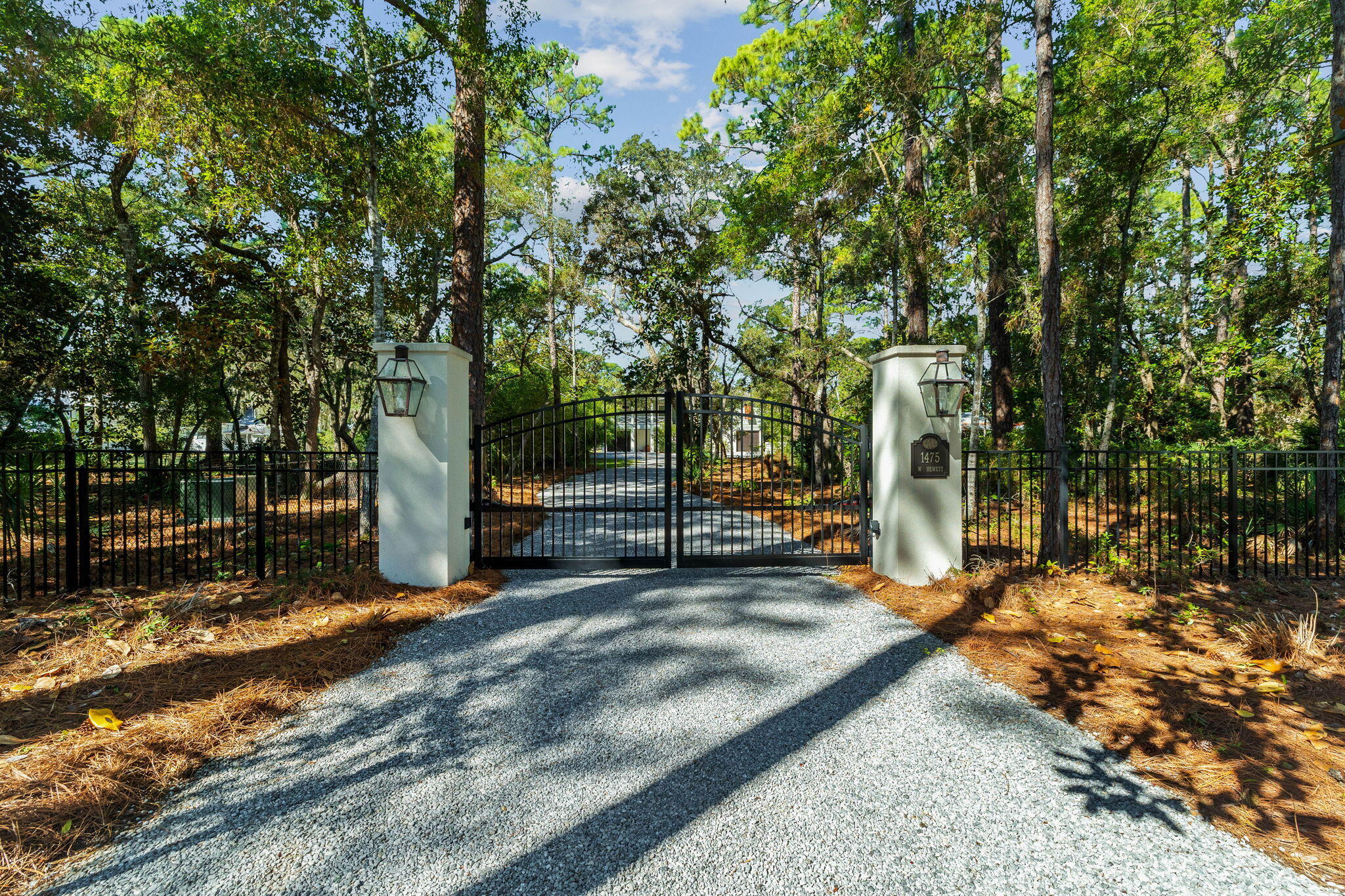 Tucked away behind private gates, this extraordinary waterfront estate redefines luxury coastal living on Hewett Bayou with .83 acres of prime bayfront land, 85 feet of year-round deep water frontage, and an impeccably designed dock—crafted for those who live life on the water. A winding drive meanders beneath a lush canopy of live oaks and towering pines, setting the stage for an estate that is both exquisite and private.

Built in 2019 by the esteemed Burrell Elliott, this masterfully constructed residence is a testament to superior craftsmanship, offering an elevated fusion of architectural refinement and modern functionality. Every detail has been meticulously curated, from the finest high-end finishes to state-of-the-art appliances, ensuring both comfort and effortless sophistication.

For the dedicated boating enthusiast, this estate is unmatched in its offerings. This 85' x 407' lot provides unparalleled privacy and space, while the fully equipped dock - boasting a 12,000-lb. covered boat lift, fresh water, power, and flow-through platform, allows for seamless docking, world-class fishing, and endless days on the open water. A full composite-decking dock ensures both durability and timeless appeal.

As the sun melts into the horizon, the waterfront transforms into a serene masterpiece, casting breathtaking golden reflections across the bayou-best enjoyed from the private pool or the elevated outdoor living space, where a 75-inch TV, sound bar, and built-in gas grill create a flawless setting for luxurious al fresco entertaining.

Inside, the chef's kitchen is nothing short of spectacular, featuring a Wolf six-burner range with griddle, Sub-Zero refrigeration, an additional full-size freezer, and a Boos custom butcher block island. A gas fireplace adds warmth to the living area, complemented by tailored window treatments and remote-controlled Hunter Douglas shades, enhancing both privacy and ambiance.

The lower level, a solid concrete block structure with oversized pilings, offers 1,120 square feet of unfinished space, wired for AC and electrical - an exceptional opportunity for expanding living quarters, a guest retreat, or a bespoke workshop. This level also features a bathroom, cast iron Kohler double sink, built-in storage, and workbenches, while composite stairs lead to the upper terrace, seamlessly blending indoor and outdoor living.

Every inch of this estate is engineered for unparalleled convenience and security, with a whole-home generator powered by a 300-gallon owned propane tank, two tankless water heaters, a full water filtration system, Private Well, and Reme Halo UV light air purifiers in both AC handlers. The meticulous attention to detail extends to stainless steel hardware throughout, and every window and door is expertly cased for durability. 

The option to create a magnificent family compound is available by combining with the adjacent lot for sale, effectively doubling the size to 1.66 acres.  
 
Fine dining, luxury shopping and leading hospital and medical care are just minutes away. This is more than a home - it is a legacy estate, an exclusive retreat, and a once-in-a-lifetime opportunity to own a meticulously designed coastal sanctuary, where boating, fishing, and effortless luxury converge in perfect harmony.