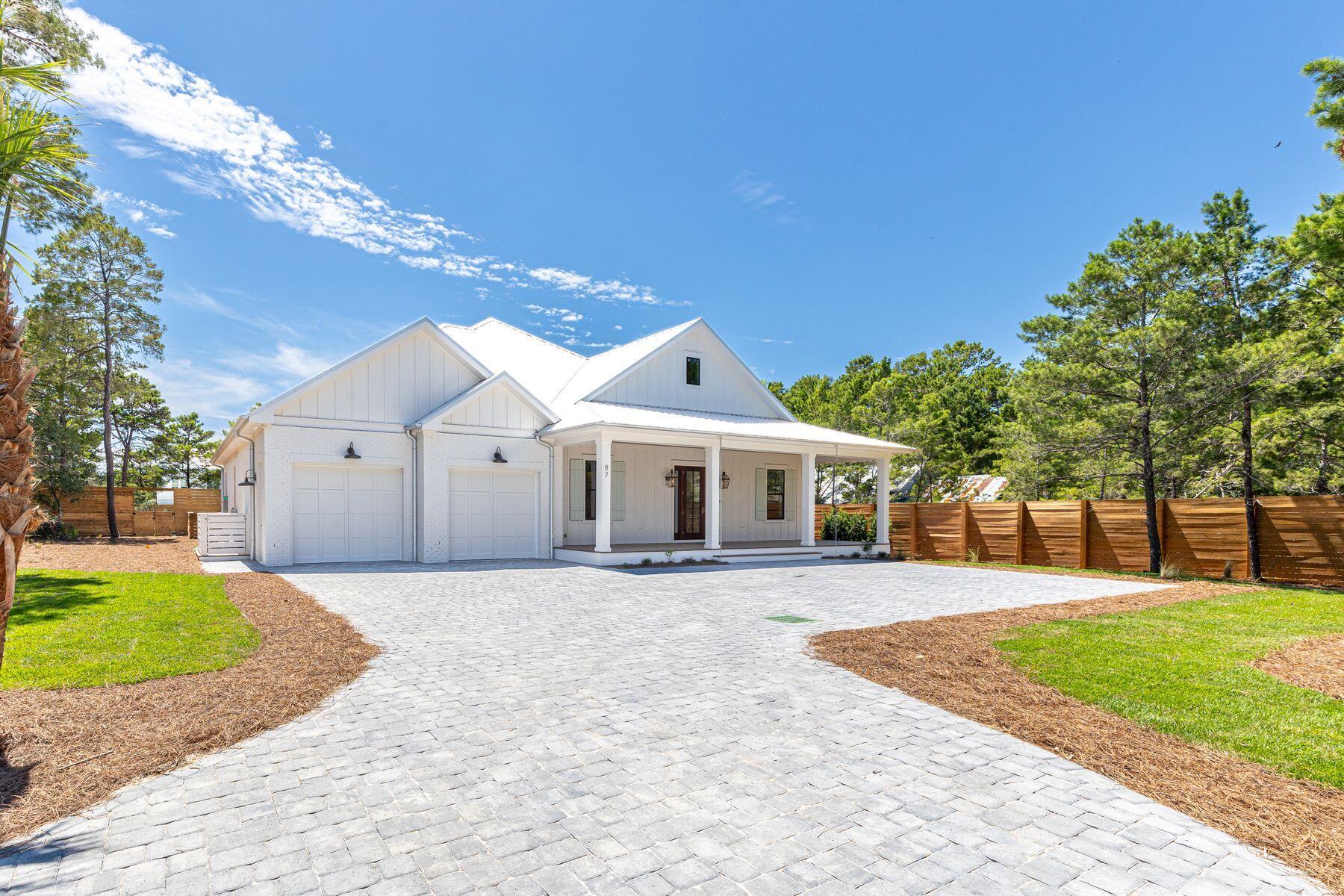 Introducing an exceptional single-story new construction on a half-acre in Blue Mountain Beach, less than 2 miles from the beach. This 5-bedroom, 4.5-bath home offers more than 3,500 sq. ft. of refined living space, thoughtfully designed for both family and entertaining. Soaring 12' ceilings with exposed beams, pecky cypress accents, and warm coastal finishes create a timeless feel. The chef's kitchen features white oak cabinetry, premium appliances, and a spacious wet bar, and flows seamlessly into the dining and living areas. A gas fireplace anchors the living room, while large windows frame views of the private pool, spa, and oversized screened porch--ideal for year-round indoor-outdoor living. With 4,800 sq. ft. under roof, abundant storage, and a quiet neighborhood with no HOA, this home blends luxury, comfort, and convenience to 30A. Off-street parking in the driveway accommodates up to 8 vehicles, with additional sideyard parking for an RV or watercraft. Enter from the oversized 2-car garage into a welcoming foyer-style mud room, complete with a full laundry room on one side and an oversized walk-in pantry with a second beverage center on the other. Thoughtfully planned storage and built-in shelving throughout make daily living both elegant and practical.Walk through the grand 25-ft high foyer into a bright, expansive great room. The Primary Suite is a private retreat, offering a spa-like bathroom with a soaking tub, walk-in shower, and oversized closet. On the opposite wing, the Junior Primary Suite and ensuite bath overlook the pool and garden. Two additional bedrooms share a well-designed bathroom with a shower/tub combo, while a 5th bedroom enjoys its own ensuite bath.Outdoor living is equally inviting. The pool and spa are surrounded by preserved native landscaping enhanced with mature tree selections. Beautiful shell rock pool decking is cooler on the feet, while a lawn area offers ample space for games and your pets. The expansive screened porch with an outdoor kitchen provides the perfect backdrop for poolside gatherings, evening relaxation after the beach, or weekend cookouts with friends.Located along scenic Highway 30A, this home offers unmatched access to both convenience and recreation. Trails in the State Forest, the 25-mile Timpoochee bike path, and the sugar-white beaches are just minutes away, along with world-class dining, shopping, and schools. Blending privacy, convenience, and modern coastal luxury, this single-level home is the perfect setting for life at the beach.