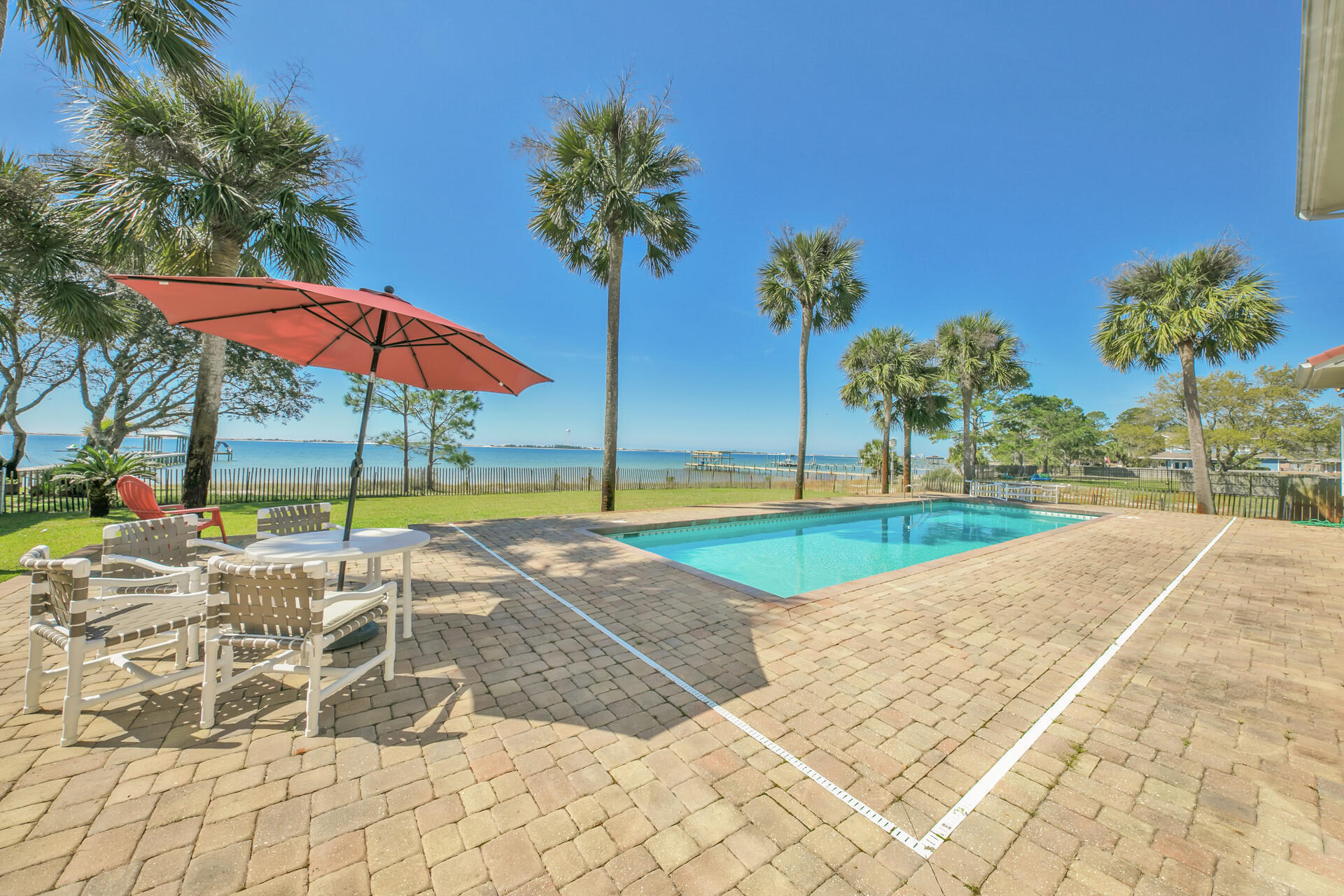 Sound Side Solitude awaits! Enjoy the waterfront lifestyle in this beautifully maintained home. A RARE find! Located on a large private lot in a neighborhood with only 16 waterfront homes & no HOA, this home offers room to breathe & a spectacular view from most every room! This five-bedroom, five one-half bath carpet free home offers 100 feet on Santa Rosa Sound. Features include a ''safe'' area, a large ground floor bonus room, office, study, exercise & separate living spaces. The remodeled kitchen has clean lines and stainless appliances. The expansive great room opens to breathtaking outdoor space with patio & saltwater pool. Whether entertaining a large crowd or simply enjoying the day on your private beach - escape the hustle & bustle to enjoy your own Santa Rosa Sound Side Solitude!