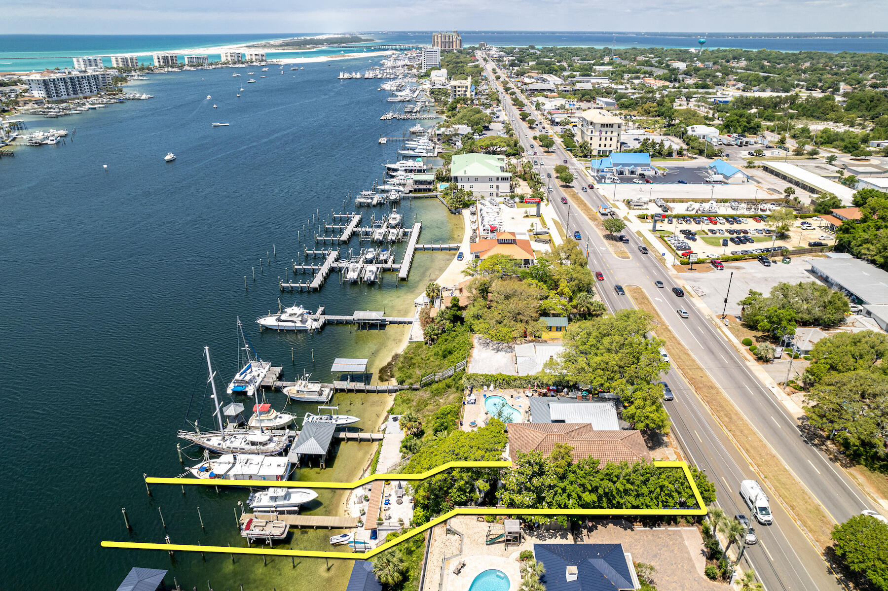 JUST REDUCED! ICF CONSTRUCTION! TURNKEY AND FURNISHED INCLUDING PONTOON BOAT! 36' Yellow Fin Vessel, Floatlift, and Trailer available for an additional $500,000! 
Spectacular Harbor-Front Estate in Destin, Florida featuring an extraordinary elevation and view corridor to the scenic Harbor, East Pass, and Gulf of Mexico! The main house totals ±3,774 sf, 4 bedrooms, and 3.5 bathrooms. This irreplaceable setting hosts an abundance of outdoor areas for your family to enjoy and entertain guests, not the least of which include a new hot tub, sundeck, and quintessential guest cottage, totaling ±495 sf, at the dock level, enjoying convenient access to two deep-water boat slips with boat lifts. The owner has maintained the home and improvements to perfection, while integrating the following new features and upgrades: renovation of all exterior shutters and architecturally magnificent, salvaged doors, all new paint and stain throughout, Wi-Fi hotspot throughout grounds and both structures, renovated garage doors, new kitchen countertop and backsplash, new kitchen cabinet hardware, new steamer in primary bath, new Rinnai point of use whole main house system. The legacy old-growth trees that grace this property are fabulous.  Subject property is being sold furnished and some exclusions shall apply. Please inquire for further details and to schedule your private showing.