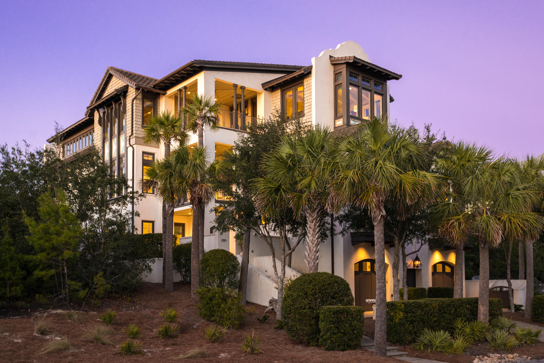 A Dutch Caribbean style villa, with exquisite interior appointments, stunning design and a lakefront lot in one of the most coveted private communities on 30A. Built in The Retreat, this home is styled with parapet walls and a smooth stucco coating over the cement block exterior. Step into the private courtyard entrance and be enveloped in breathtaking finishes, stunning detail and meticulous planning that went into creating this beach manor. Distinctive floor and ceiling treatments of marble, Tabby stone, stone tile, Oak and a scissor-truss cathedral ceiling inspire grace and grandeur. Hosting and entertaining guests will be effortless with luxury amenities like an attached carriage house suite located above the garage, private elevator that services all three floors, bunk room with a Japanese soaking tub, a dedicated media room, grilling porch, large outdoor living area with a firepit and a custom modern kitchen with a wine room. The expansive open living space, and large private balconies allow for easy indoor/outdoor living. The entire third level of this home is dedicated to the master retreat with bedroom views that gaze towards the Gulf, and a private balcony that captures both sunrise and sunset. Twin vanities, a dual steam shower and a two-person light therapy tub that fills from the ceiling creates a spa-like atmosphere. From the third floor workout loft extends an acrylic catwalk that floats over the living room and ends with a spectacular secluded lakefront view. Just steps from the back porch, residents have access to a private dock on Draper Lake where kayaks and paddle boards can be launched into calm waters which are intermittently connected to the Gulf of Mexico. Across the street is the most scenic beach access in The Retreat, skirting majestic dunes as it approaches 3,000 feet of pristine private beach front.