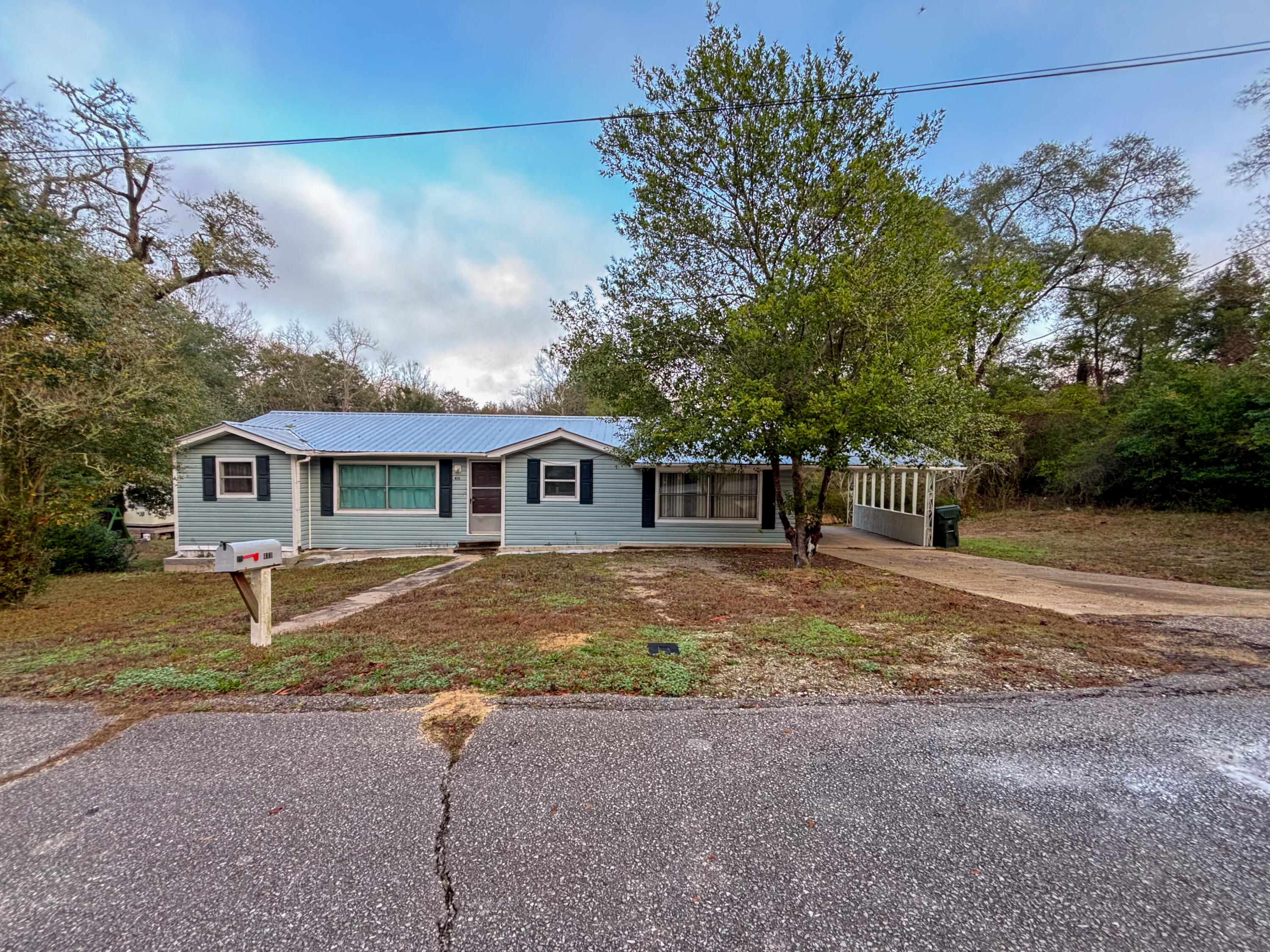Welcome to this spacious and well-located in-town home offering versatility, charm, and room to grow. Situated on a generous 0.36 acre lot, this property features a large yard with plenty of space for outdoor enjoyment, gardening, or future improvements.

The home offers a functional layout that includes a welcoming entry/foyer, a separate dining room, and a comfortable living room, creating great flow for everyday living and entertaining. A covered carport provides convenient parking and protection from the elements.

Inside, the property currently functions as a 4-bedroom, 2-bath home (bedroom/bath count not reflected on the property appraiser), offering flexibility for a growing household, guests, or home office space. The interior showcases updated flooring, fresh neutral tones, and an updated kitchen with modern cabinetry and countertops.
Located within town limits, this home offers a great central location close to schools, shopping, dining, and local amenities combining convenience with the comfort of a spacious lot.
This property presents a great opportunity for buyers seeking space, location, and functionality all in one.